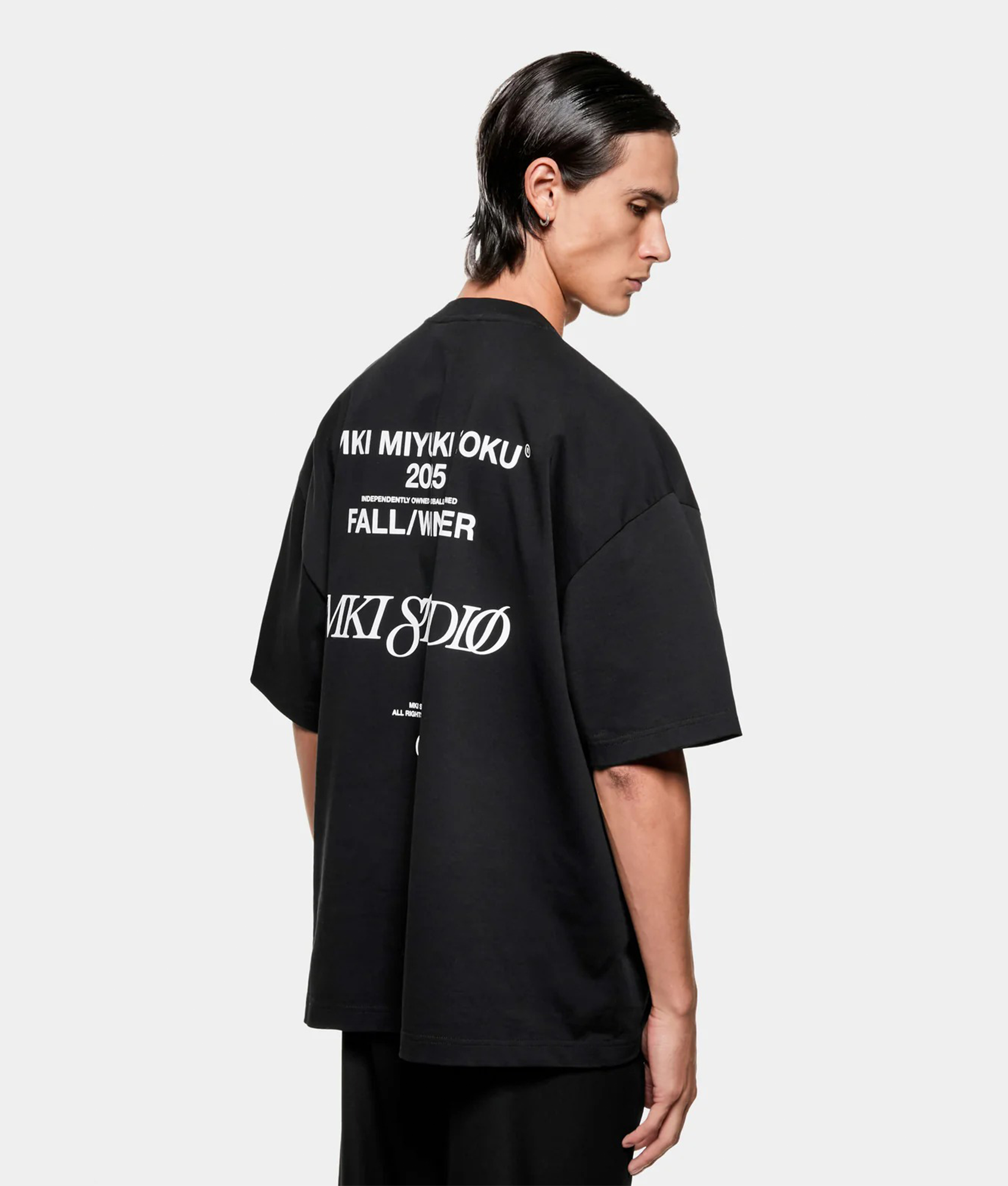 MKI MIYUKI ZOKU Script T shirt in Black at EQVVS Menswear. Angled back shot.