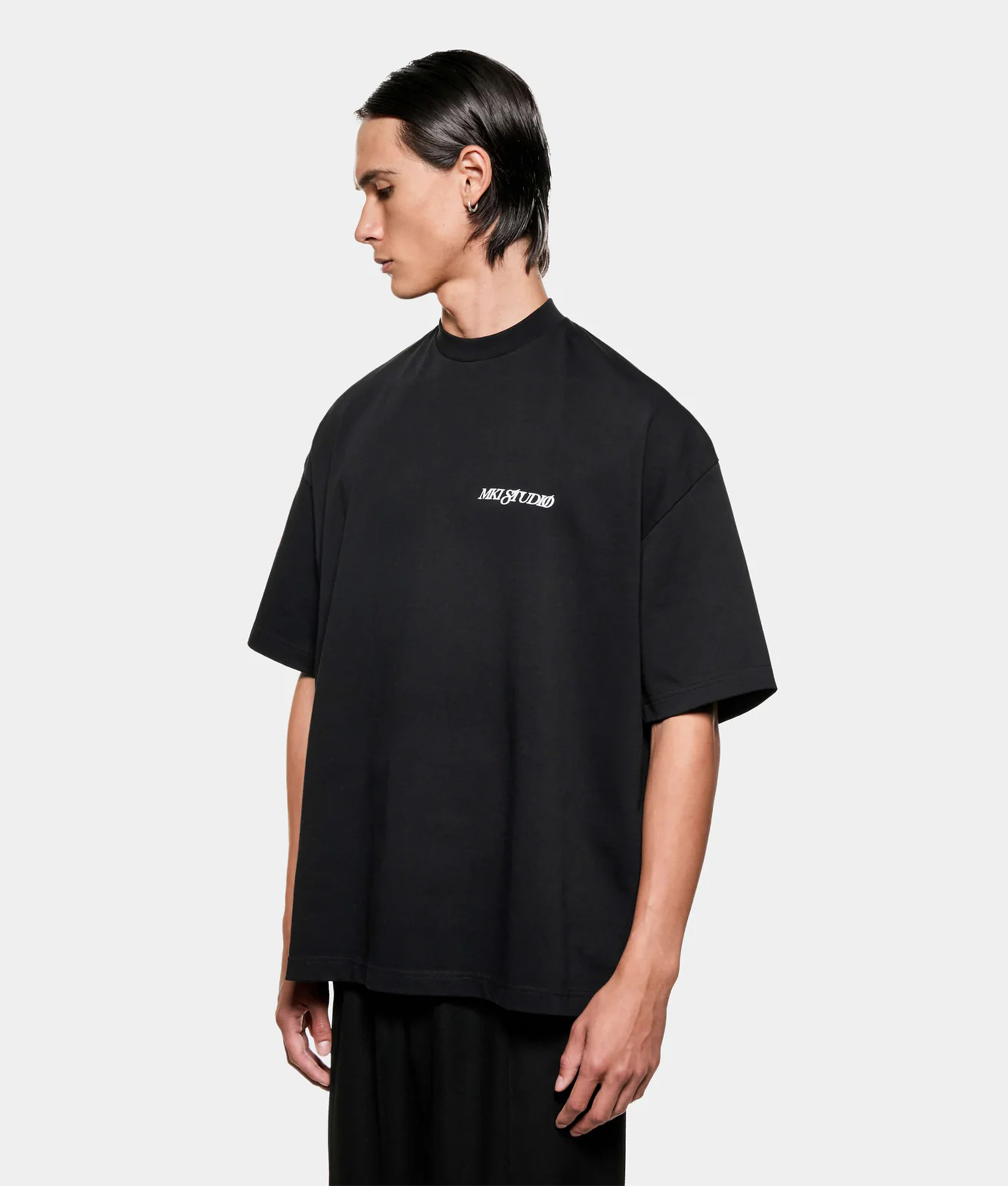 MKI MIYUKI ZOKU Script T shirt in Black at EQVVS Menswear. Angled model front shot.