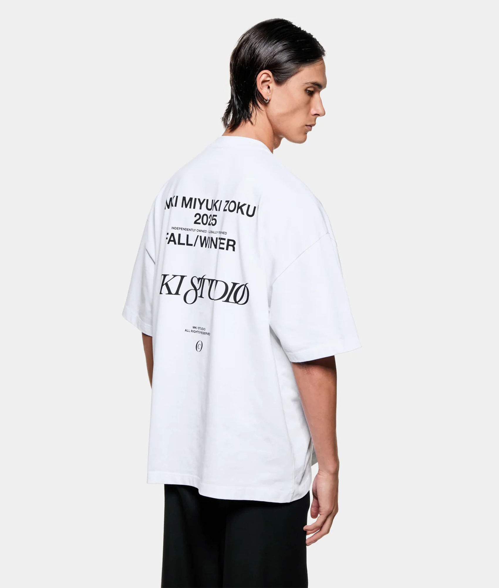 MKI MIYUKI ZOKU Script T shirt in White at EQVVS Menswear. Angled back shot.