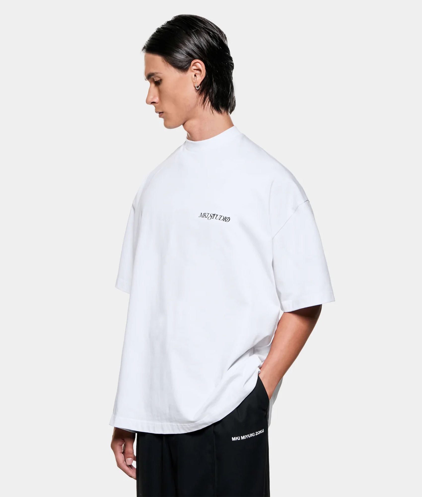 MKI MIYUKI ZOKU Script T shirt in White at EQVVS Menswear. Angled model front shot.