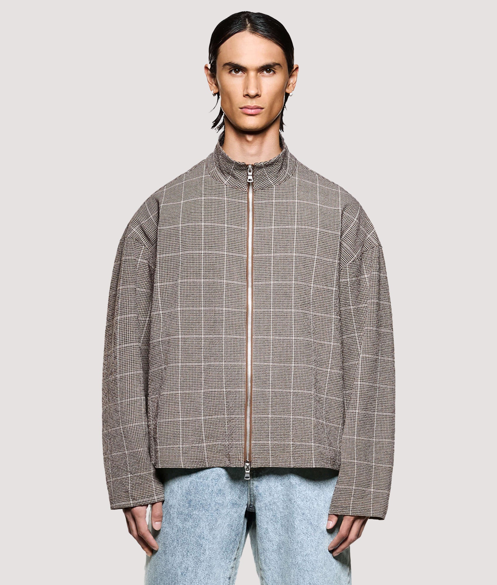 MKI MIYUKI ZOKU Box Fit Seersucker Check Track Jacket in Brown at EQVVS Menswear. Model front shot.