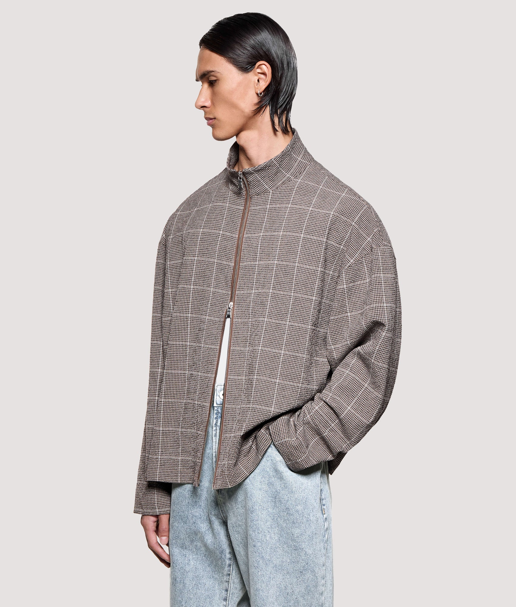 MKI MIYUKI ZOKU Box Fit Seersucker Check Track Jacket in Brown at EQVVS Menswear. Angled model front shot.