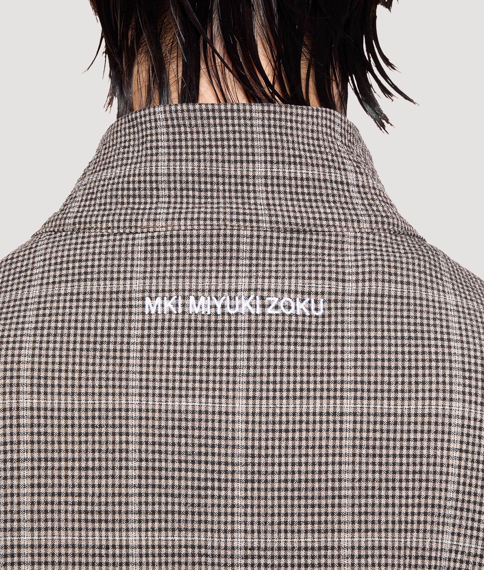 MKI MIYUKI ZOKU Box Fit Seersucker Check Track Jacket in Brown at EQVVS Menswear. Back detail shot.
