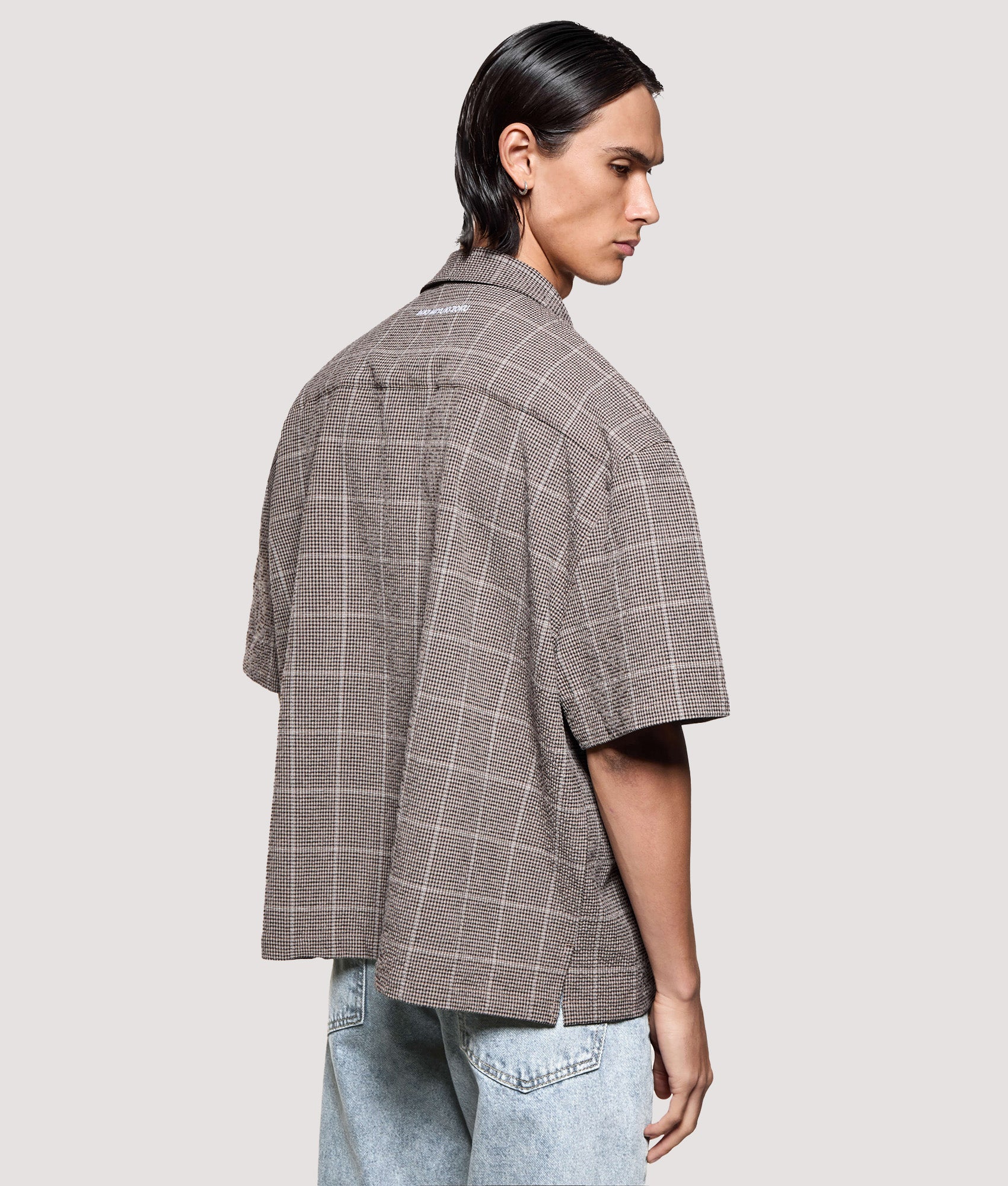 MKI MIYUKI ZOKU Box Fit Linen Short Sleeve Vacation Shirt in Brown at EQVVS Menswear. Angled model back shot.