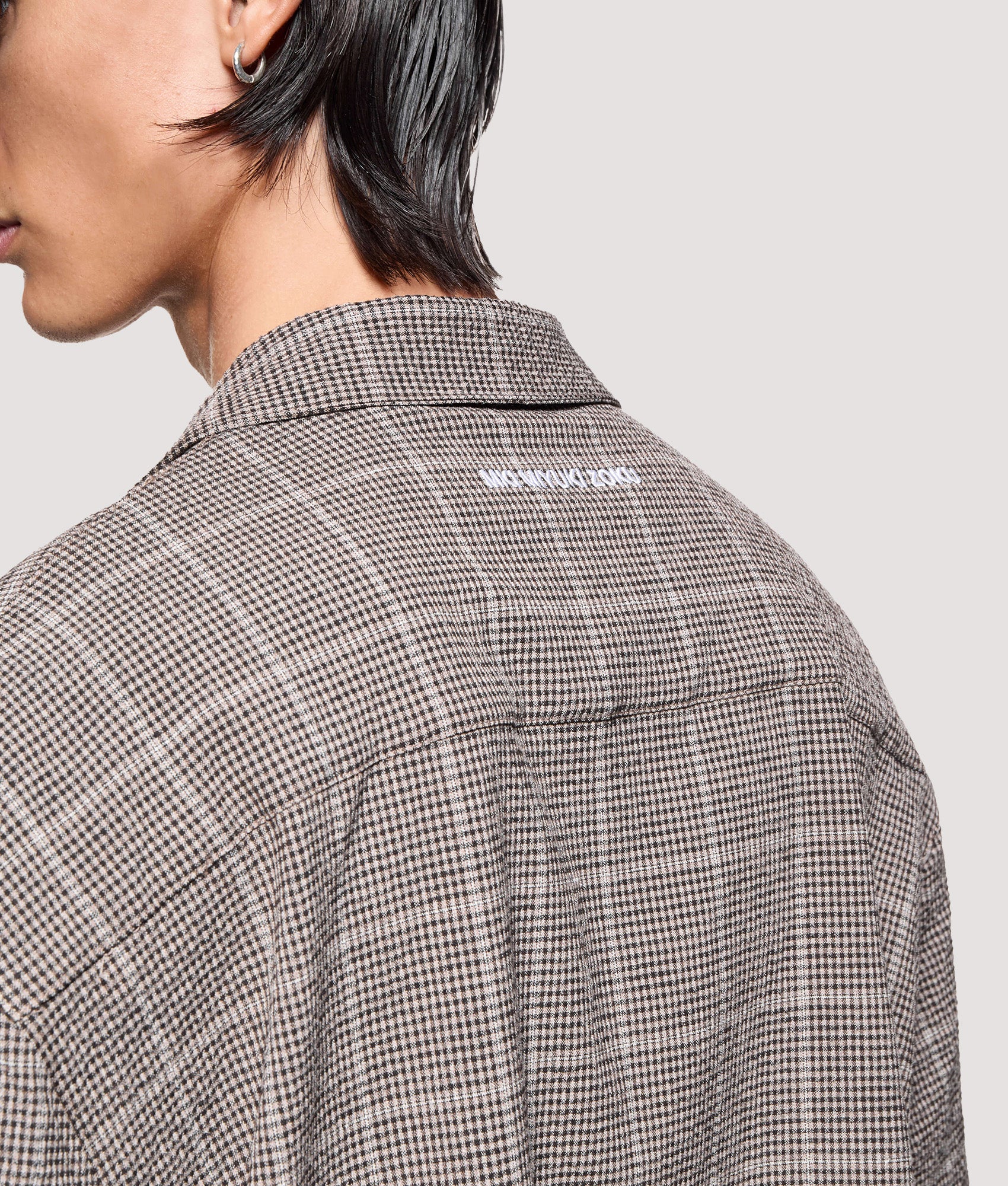 MKI MIYUKI ZOKU Box Fit Linen Short Sleeve Vacation Shirt in Brown at EQVVS Menswear. Angled back detail shot.