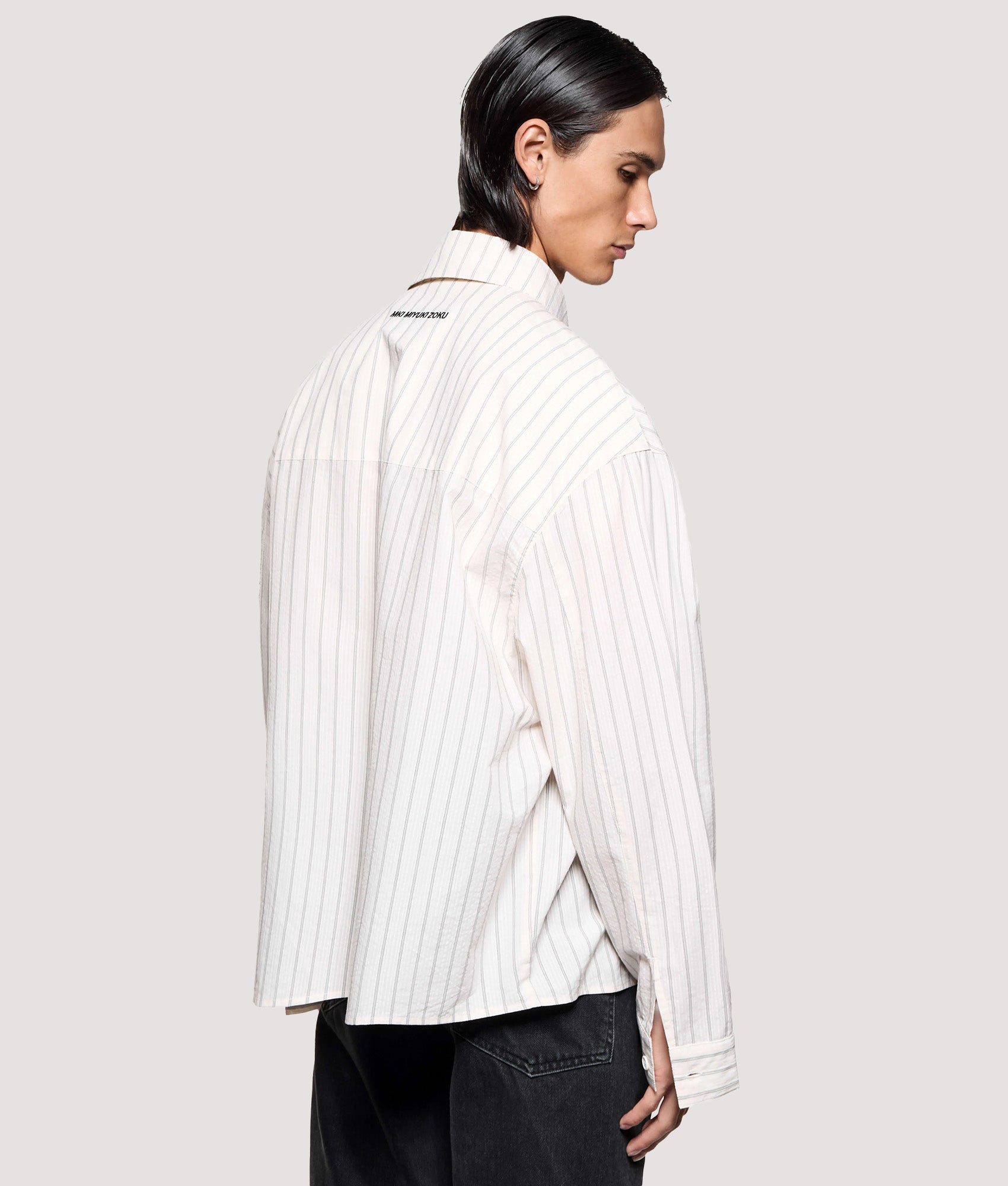 MKI MIYUKI ZOKU Box Fit Seersucker Stripe Dress Shirt in Off White at EQVVS Menswear. Angled model back shot.