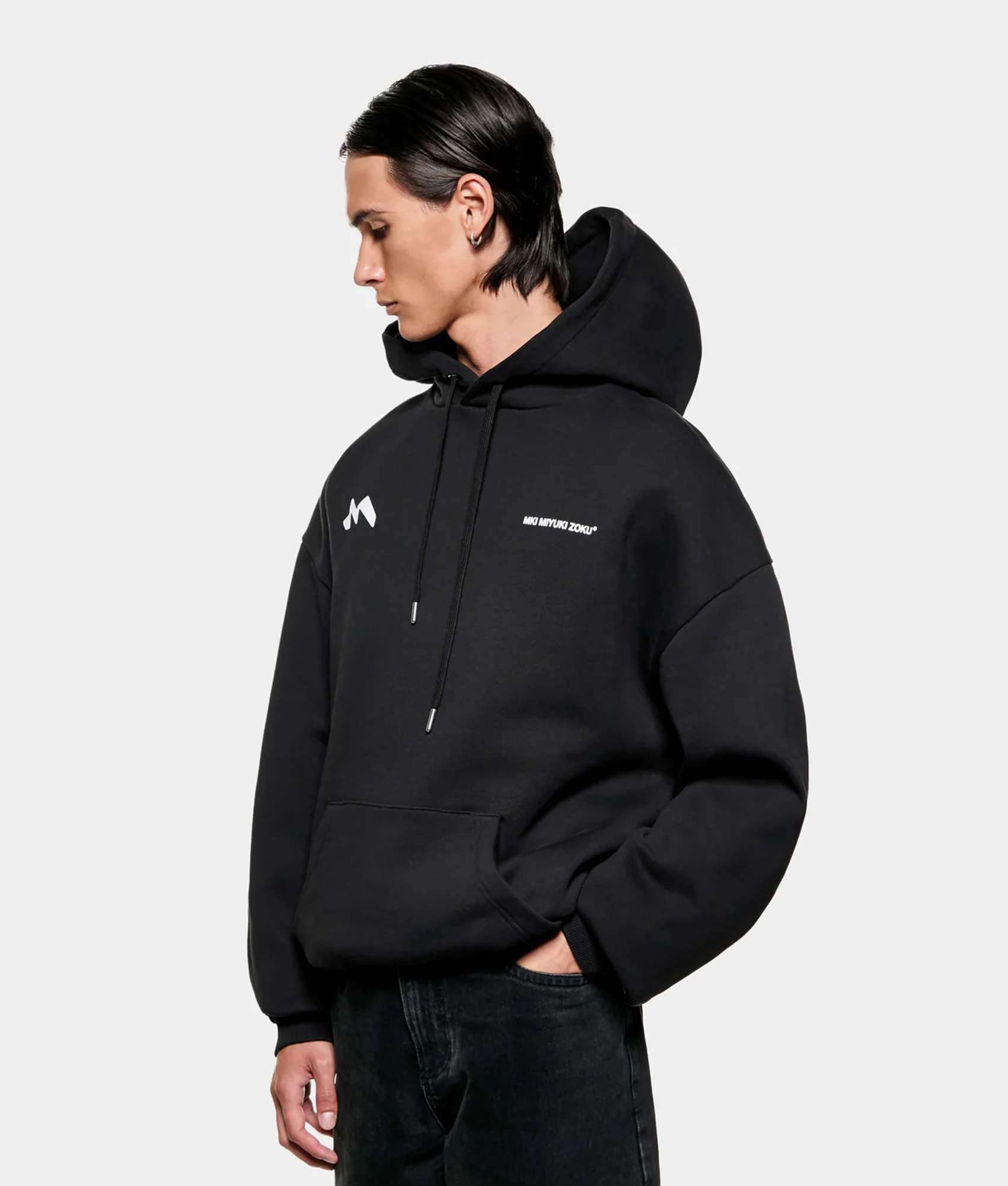 MKI MIYUKI ZOKU Silhouette Hoodie in Black at EQVVS Menswear. Angled model front shot.