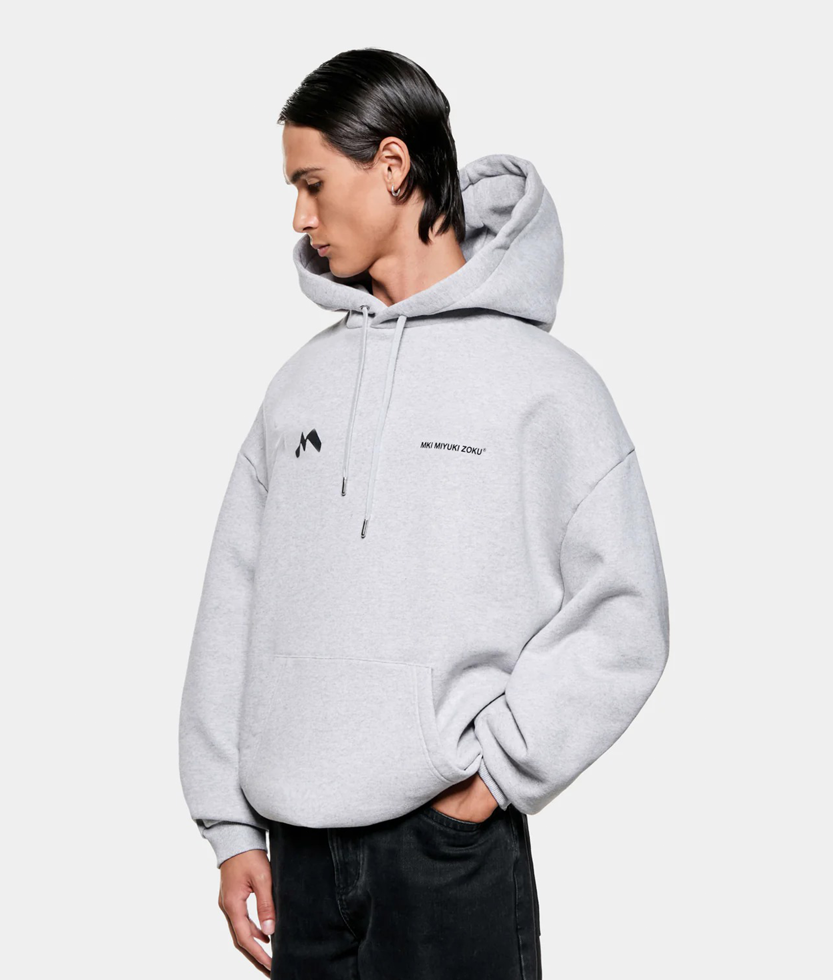 MKI MIYUKI ZOKU Silhouette Hoodie in Grey at EQVVS Menswear. Angled model front shot.