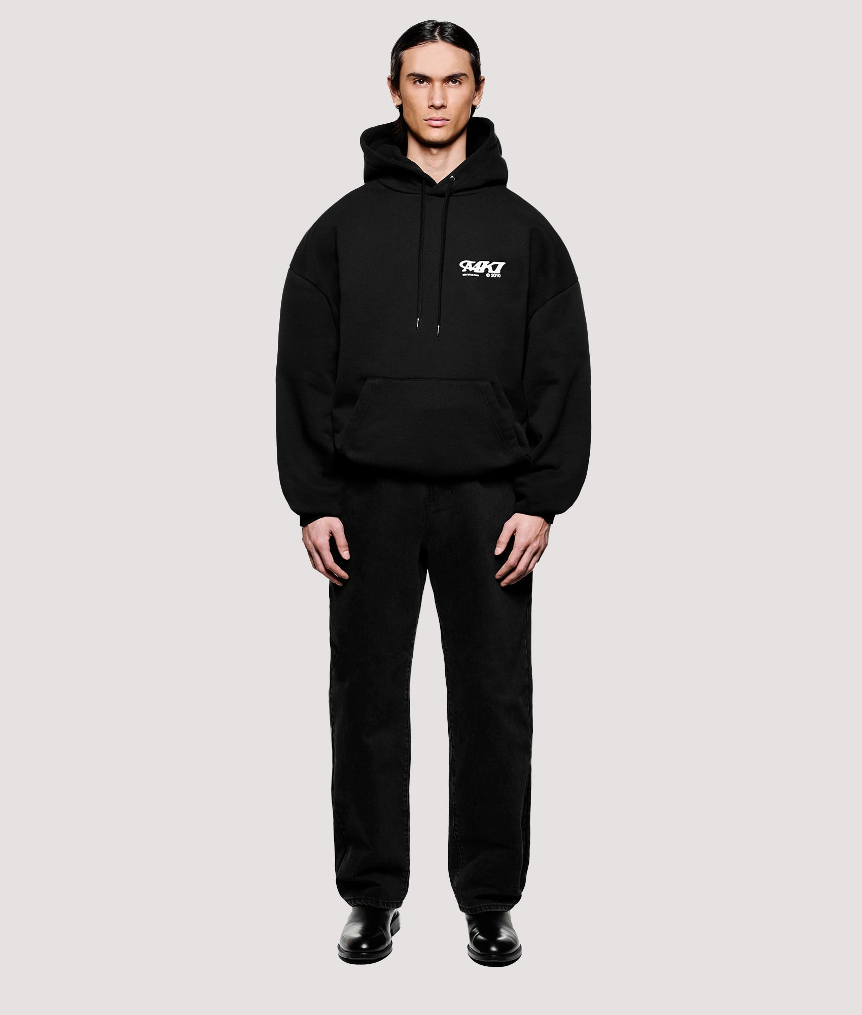 MKI MIYUKI ZOKU Box Fit Stack Hoodie in Black at EQVVS Menswear. Model front shot.