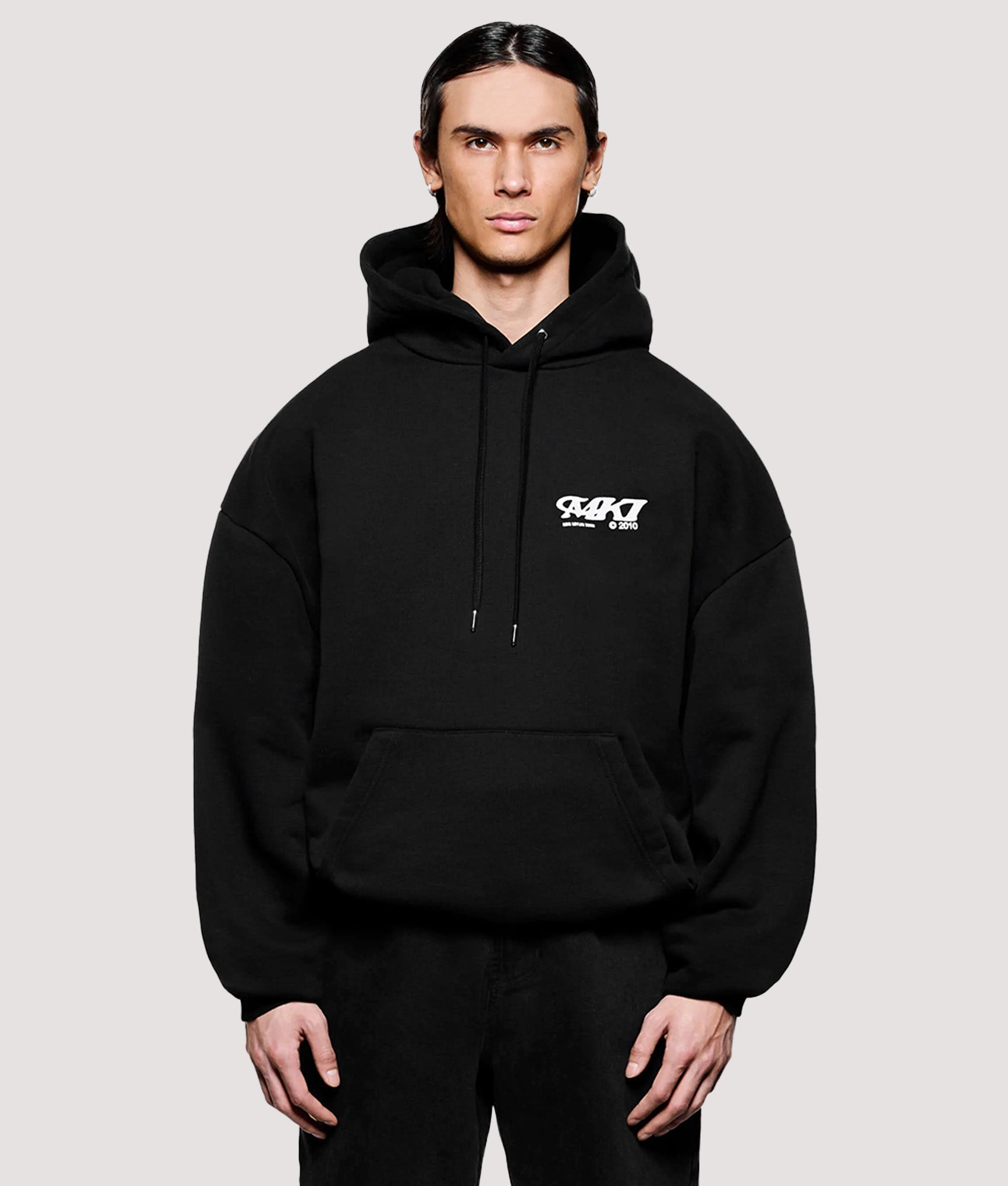 MKI MIYUKI ZOKU Box Fit Stack Hoodie in Black at EQVVS Menswear. Model front shot.