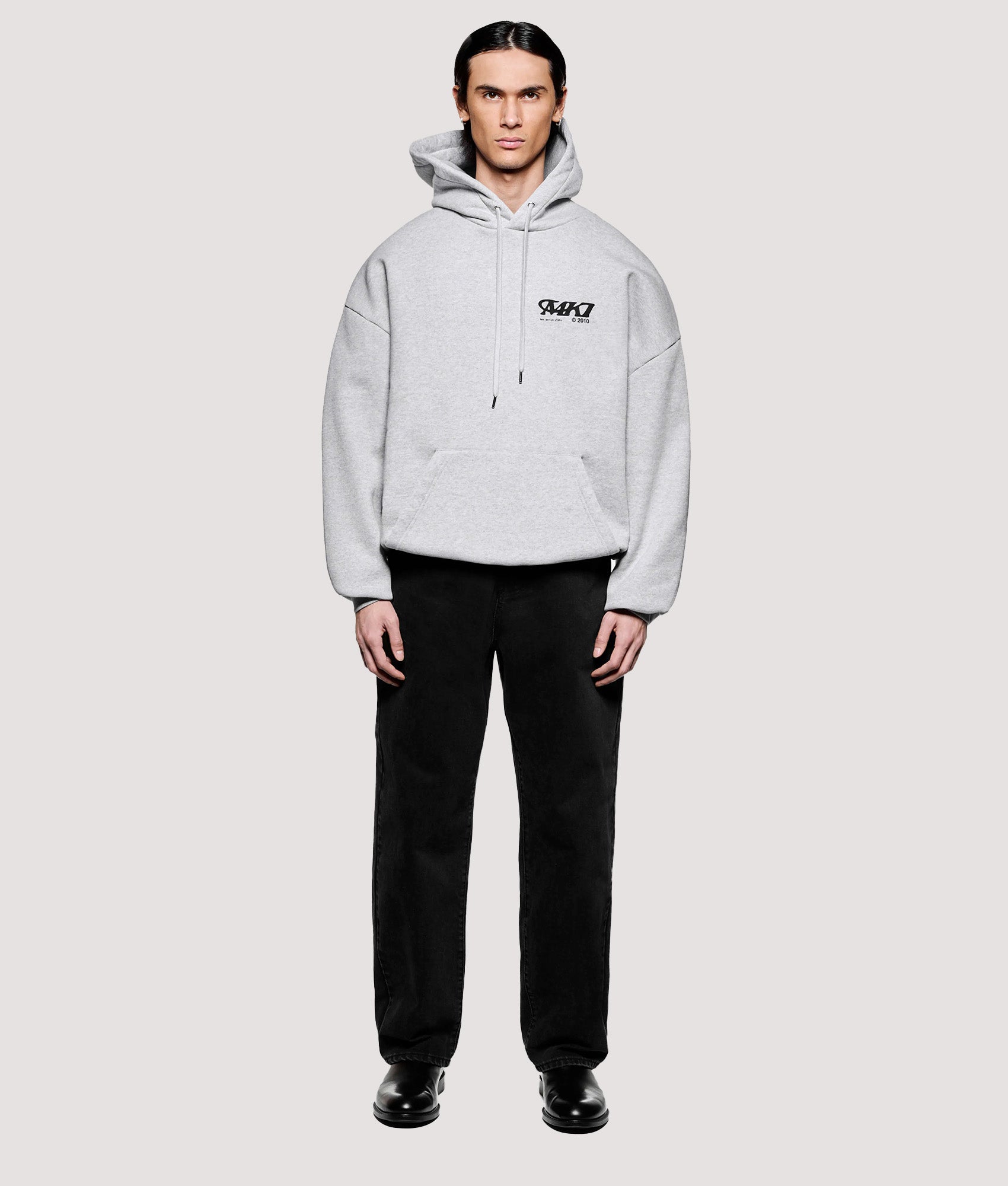 MKI MIYUKI ZOKU Box Fit Stack Hoodie in Grey at EQVVS Menswear. Model front shot.