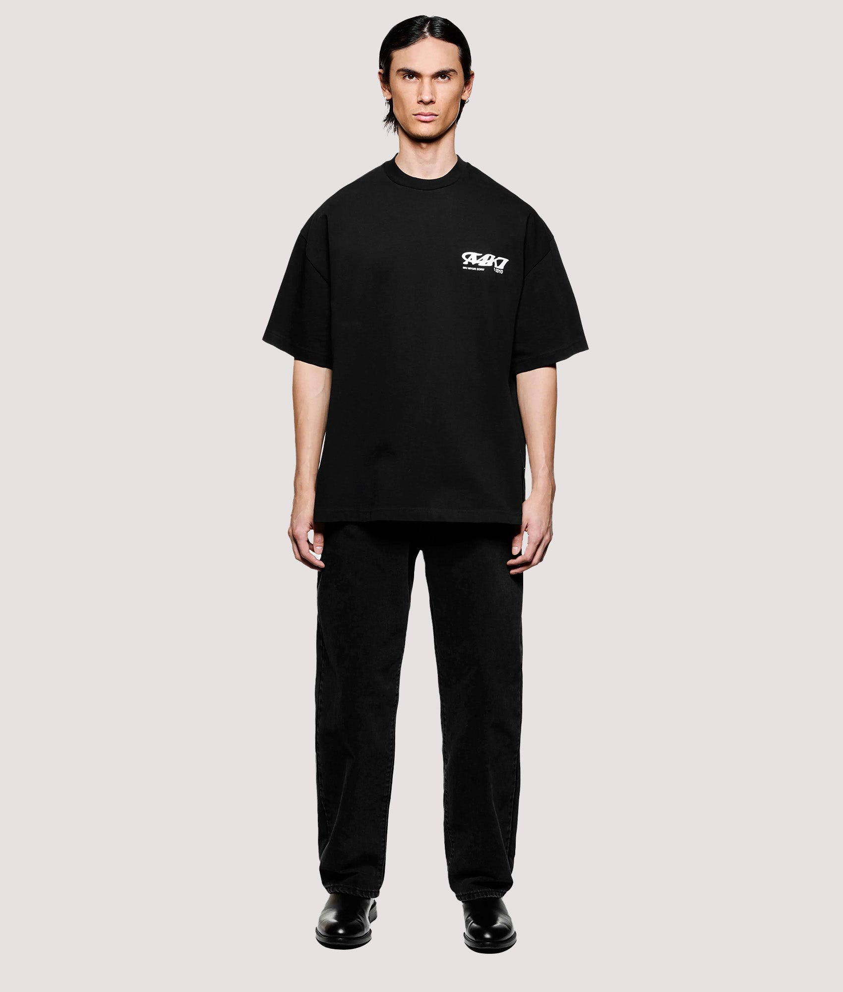 MKI MIYUKI ZOKU Box Fit Flight T-Shirt in Black at EQVVS Menswear. Model front shot.