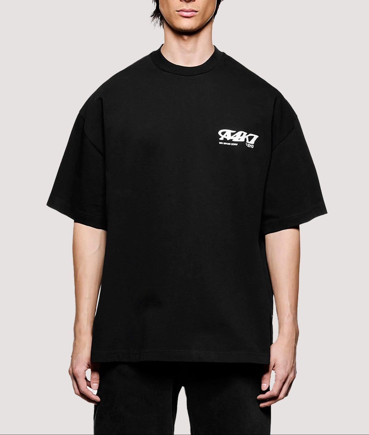 MKI MIYUKI ZOKU Box Fit Flight T-Shirt in Black at EQVVS Menswear. Model front shot.