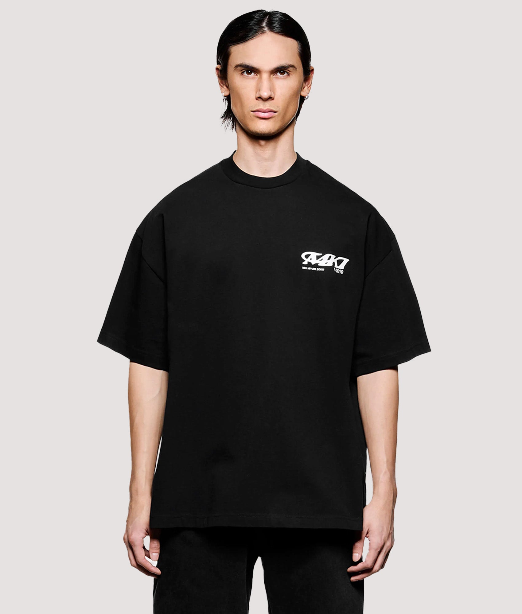 MKI MIYUKI ZOKU Box Fit Flight T-Shirt in Black at EQVVS Menswear. Model front shot.