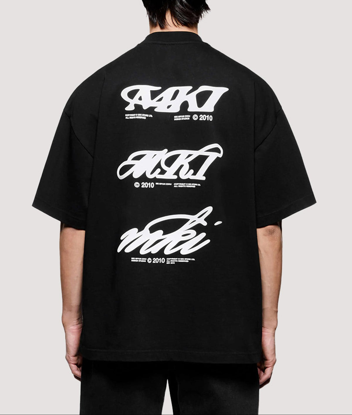 MKI MIYUKI ZOKU Box Fit Flight T-Shirt in Black at EQVVS Menswear. Model back shot.