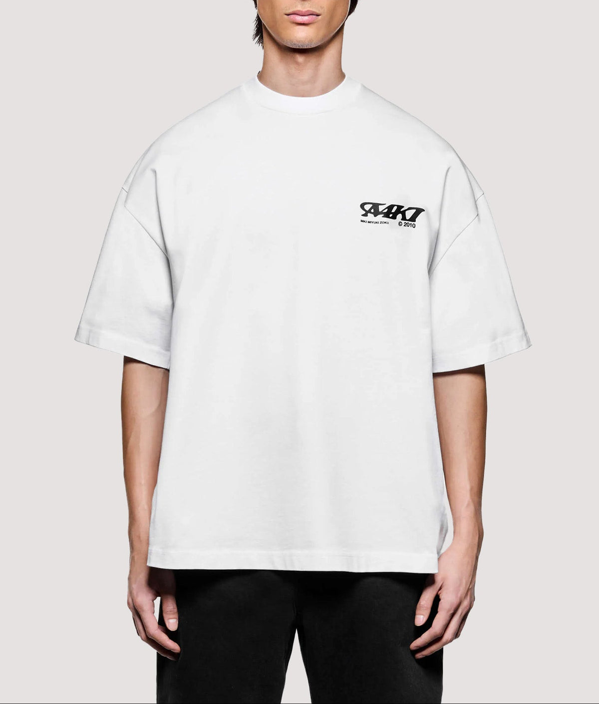 MKI MIYUKI ZOKU Box Fit Flight T-Shirt in White at EQVVS Menswear. Model front shot.