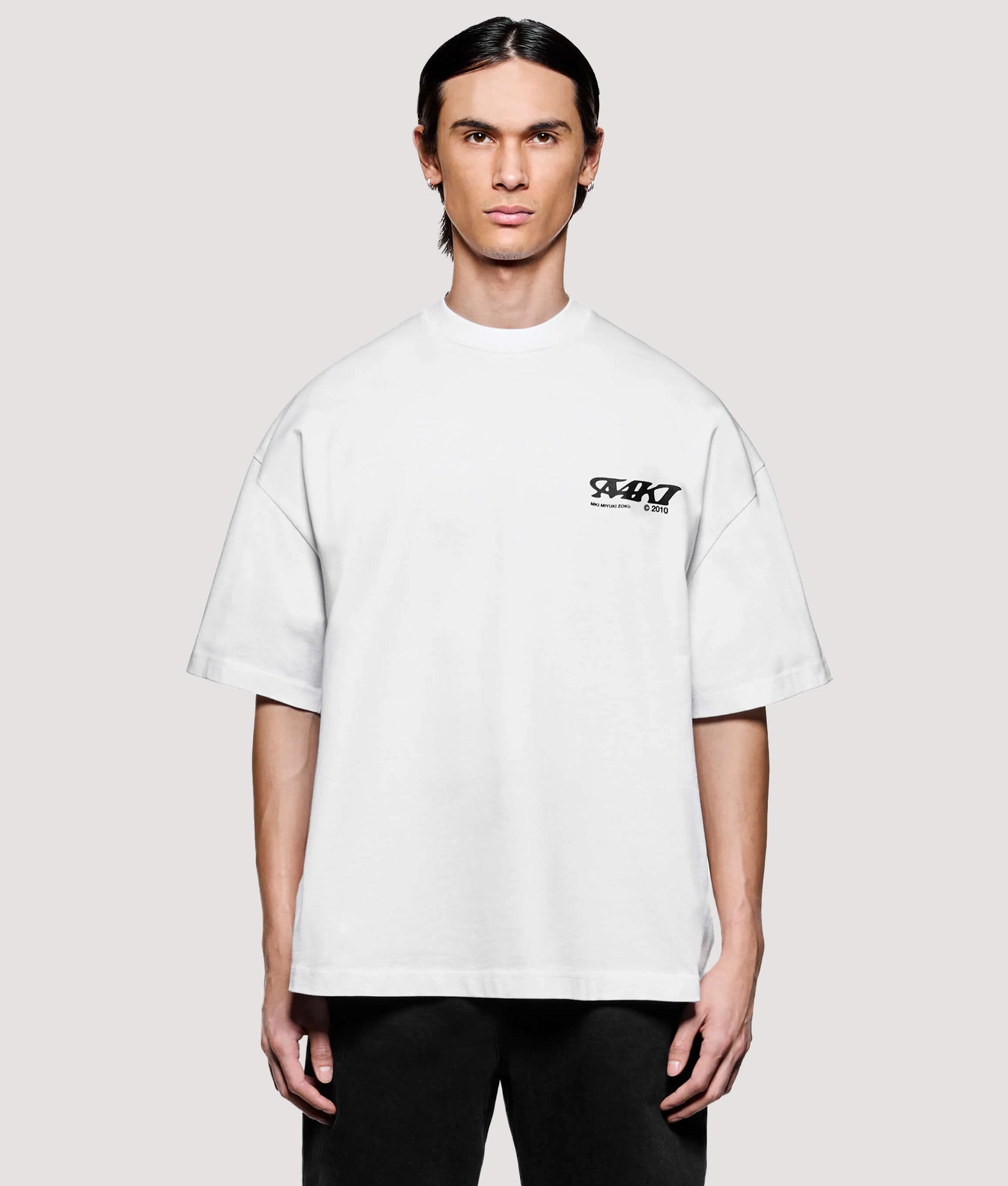 MKI MIYUKI ZOKU Box Fit Flight T-Shirt in White at EQVVS Menswear. Model front shot.