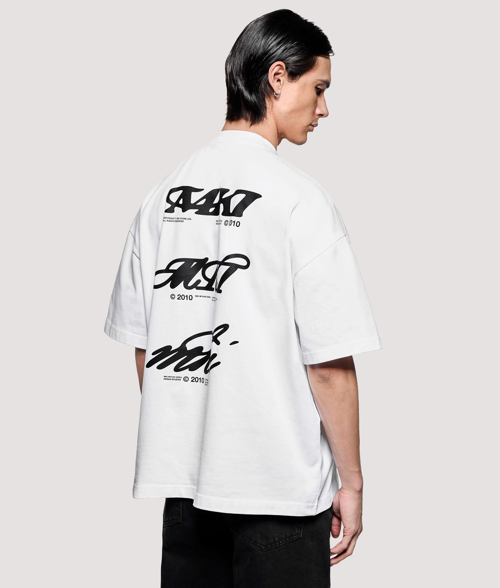 MKI MIYUKI ZOKU Box Fit Flight T-Shirt in White at EQVVS Menswear. Model angled back shot.
