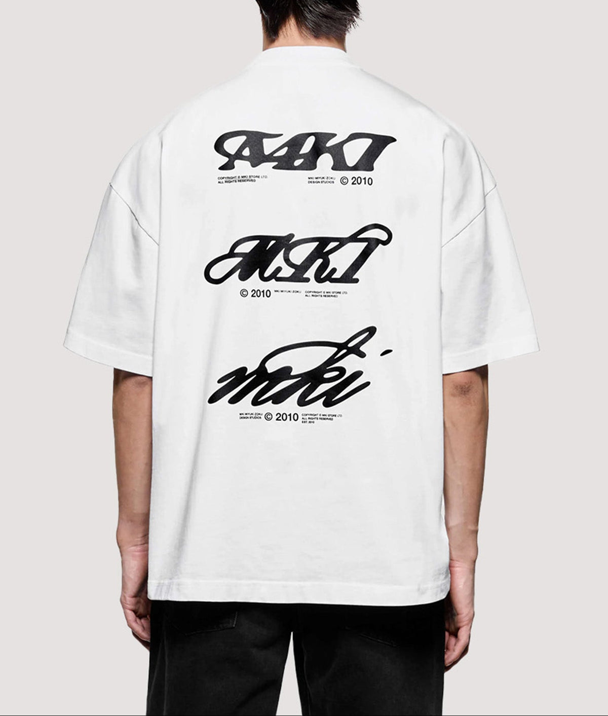 MKI MIYUKI ZOKU Box Fit Flight T-Shirt in White at EQVVS Menswear. Model back shot.