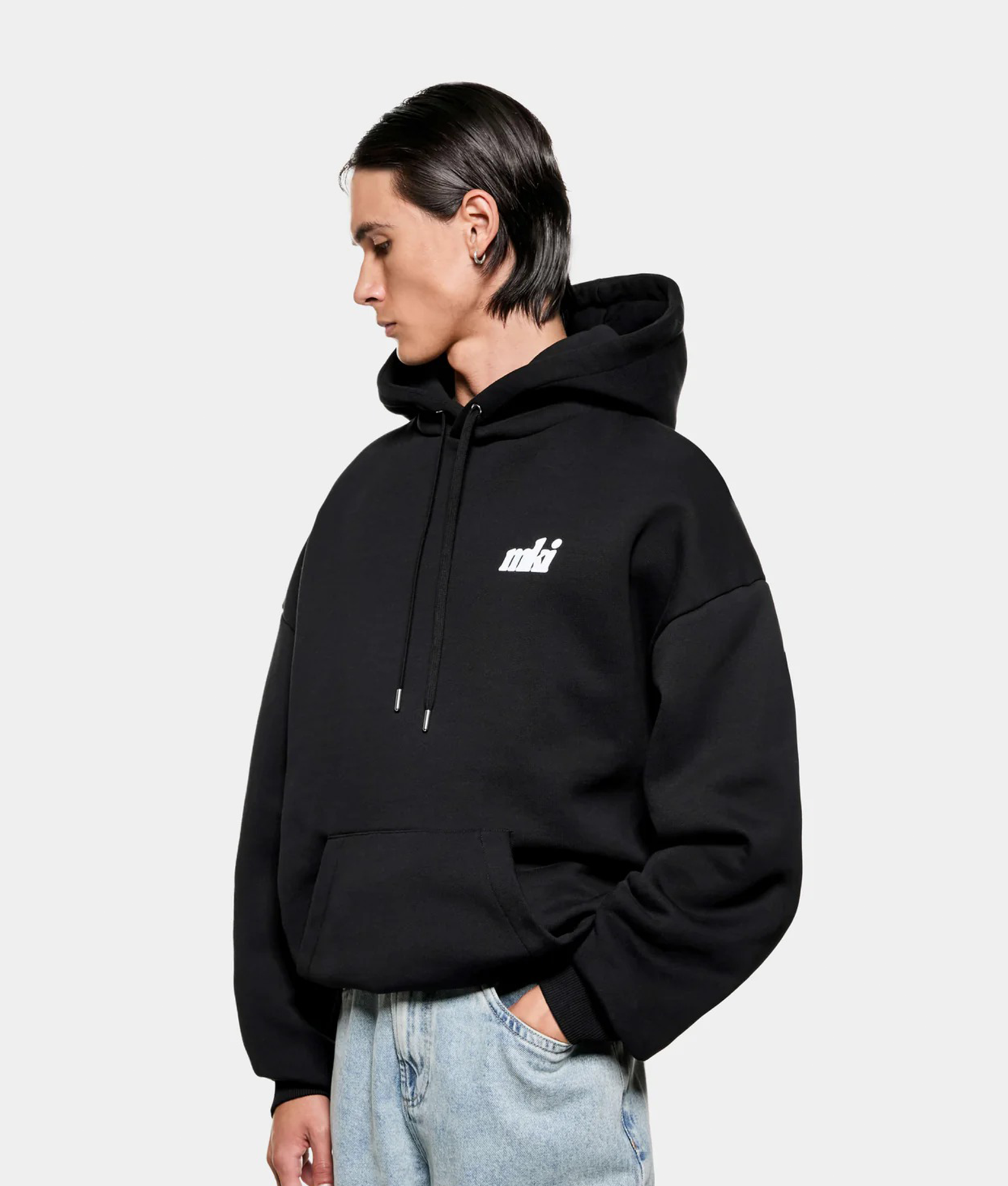 MKI MIYUKI ZOKU Stamp Hoodie in Black at EQVVS Menswear. Angled front shot.