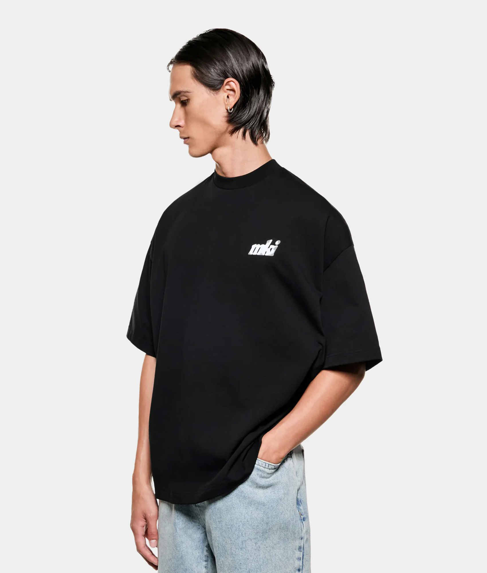 MKI MIYUKI ZOKU Stamp T-Shirt in Black at EQVVS Menswear. Angled model front shot.