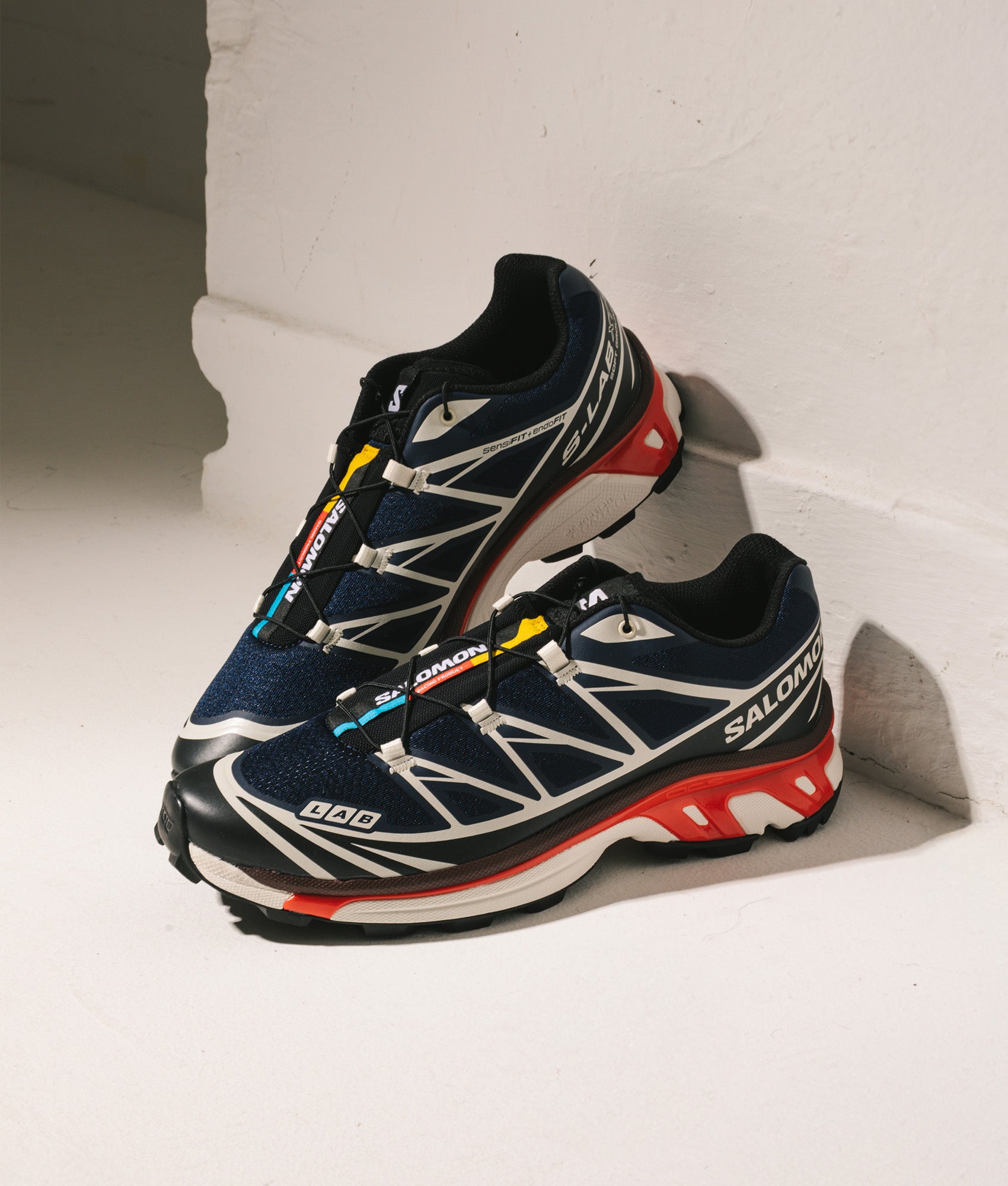 SALOMON XT-6 in Blue, Black and Fiery Red at EQVVS Menswear. Campaign shot.