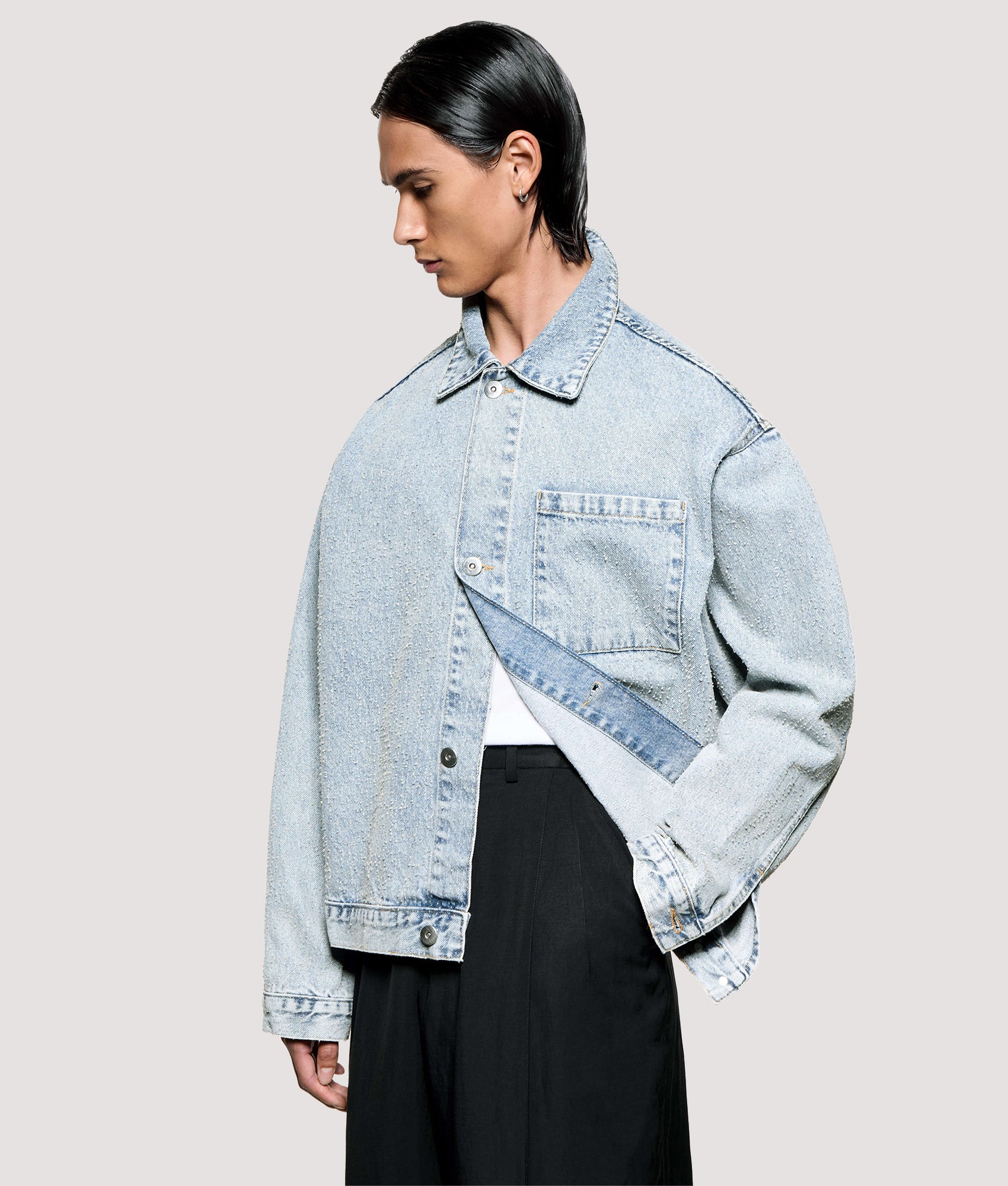 MKI MIYUKI ZOKU Box Fit Twisted Weave Trucker Jacket in Bleach Wash at EQVVS Menswear. Angled model front shot.