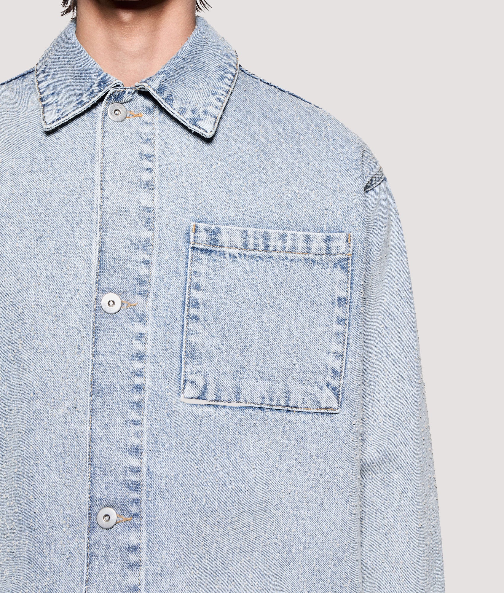 MKI MIYUKI ZOKU Box Fit Twisted Weave Trucker Jacket in Bleach Wash at EQVVS Menswear. Pocket detail shot.