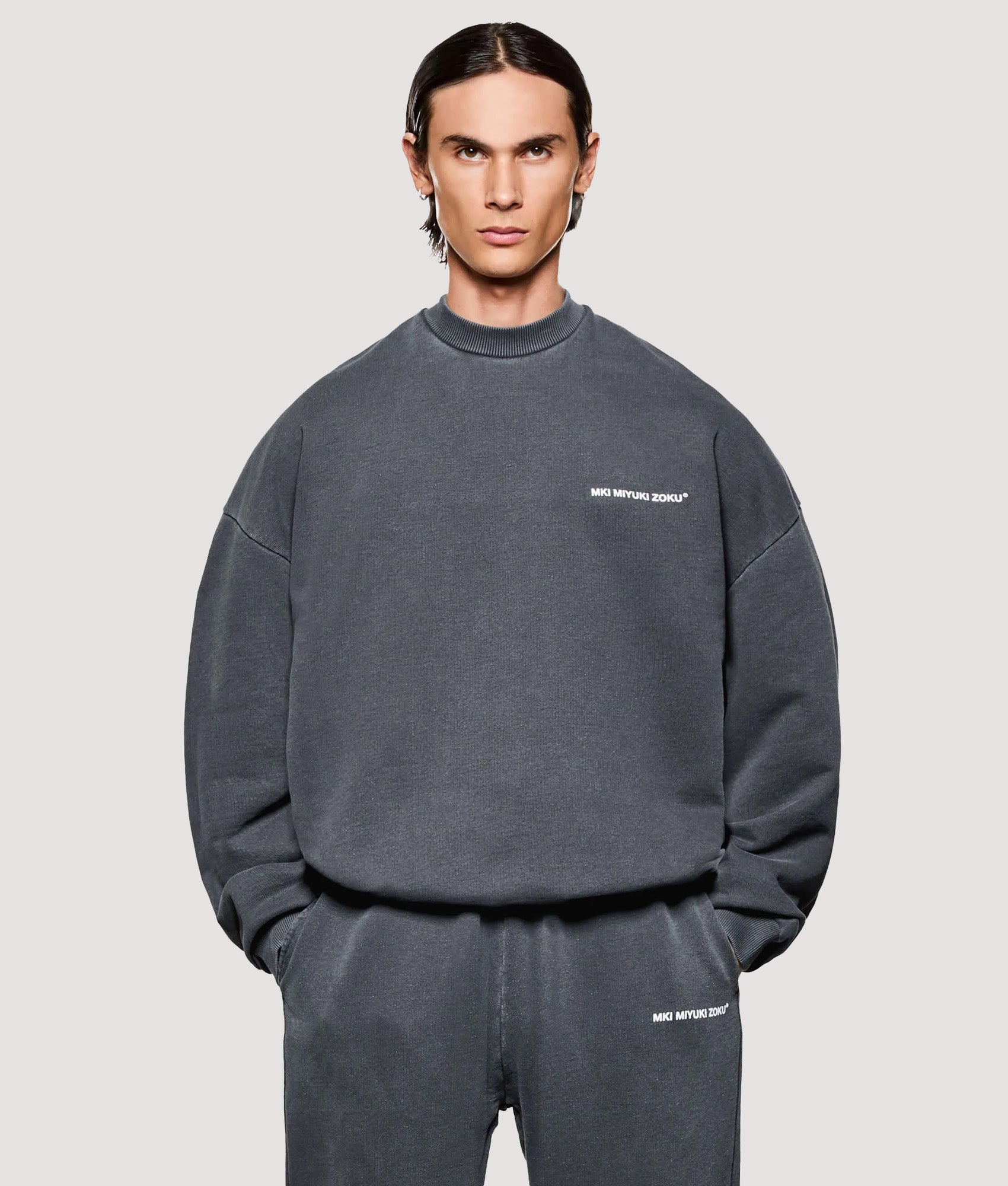 MKI MIYUKI ZOKU Box Fit Uniform Crewneck Sweatshirt in Pigment Black at EQVVS Menswear. Model front shot.