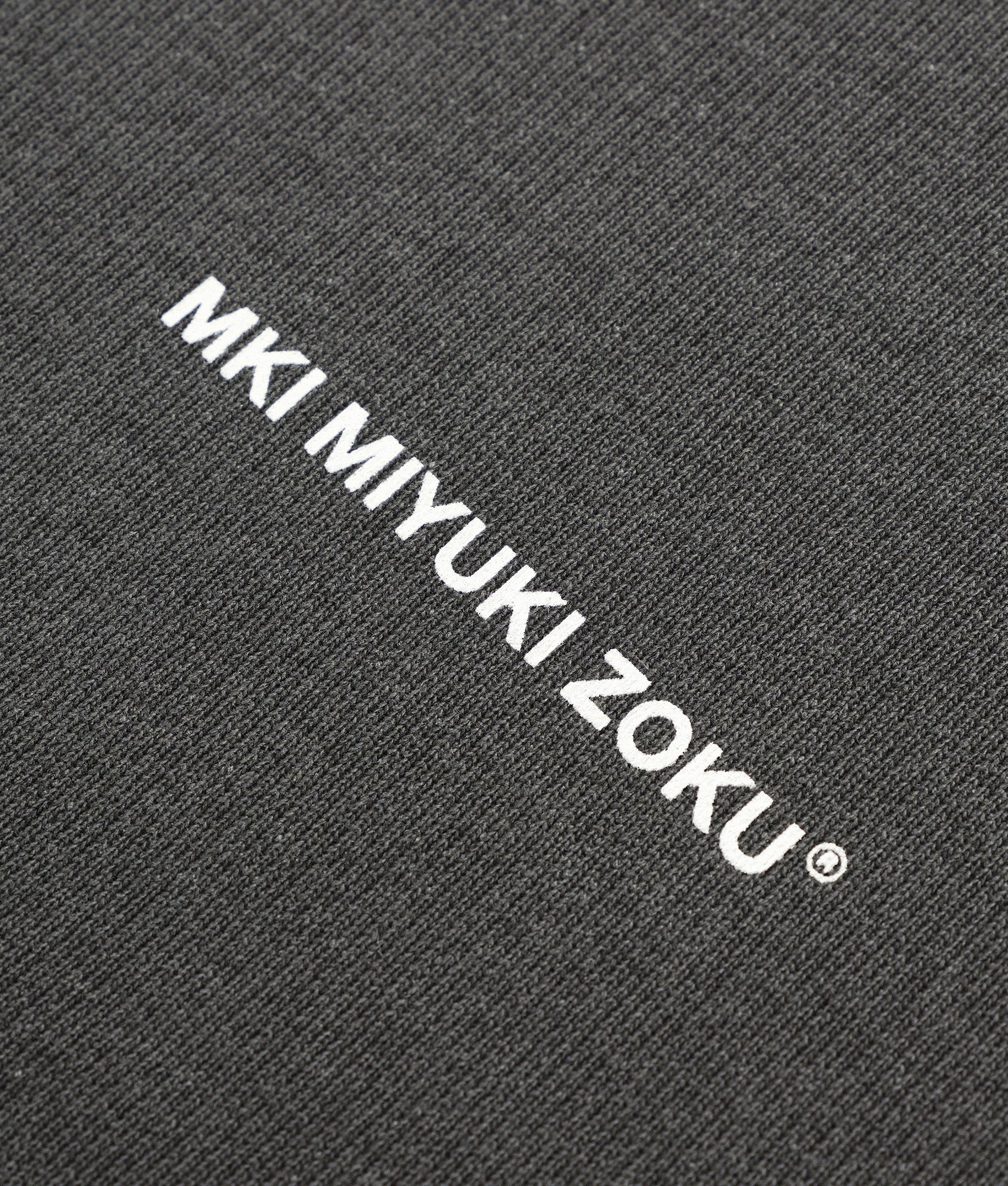 MKI MIYUKI ZOKU Box Fit Uniform Crewneck Sweatshirt in Pigment Black at EQVVS Menswear. Detail shot.