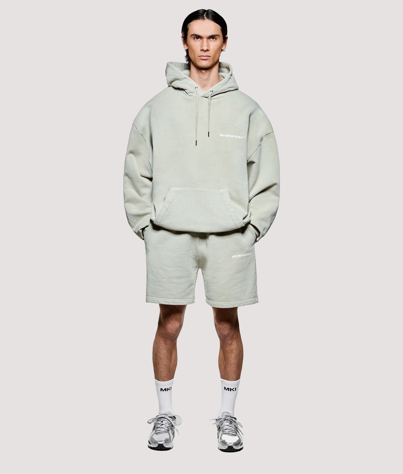 MKI MIYUKI ZOKU Box Fit Uniform Hoodie in Pigment Cement at EQVVS Menswear. Model front shot.