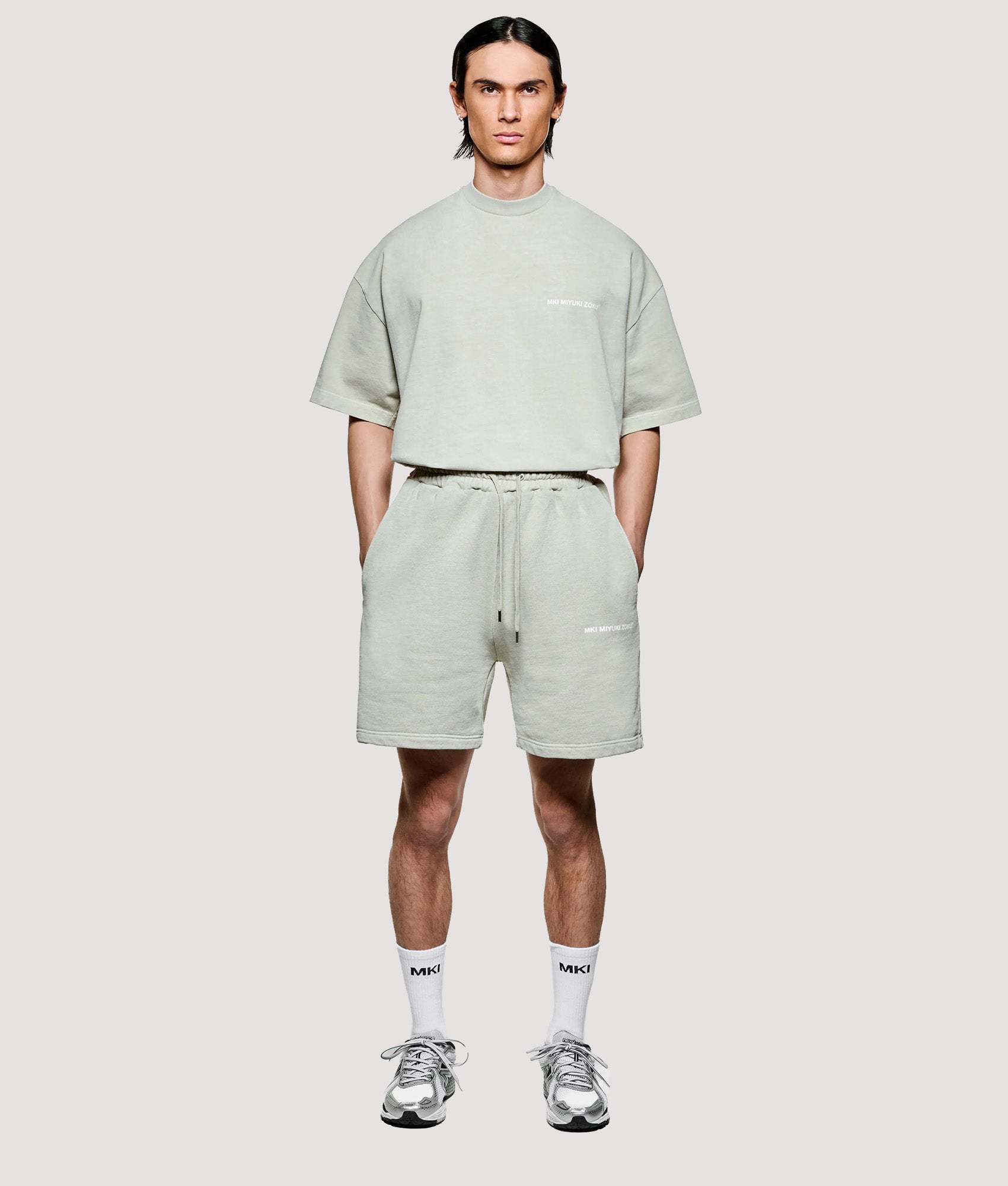 MKI MIYUKI ZOKU Relaxed Fit Uniform Shorts in Pigment Cement at EQVVS Menswear. Model full front shot.