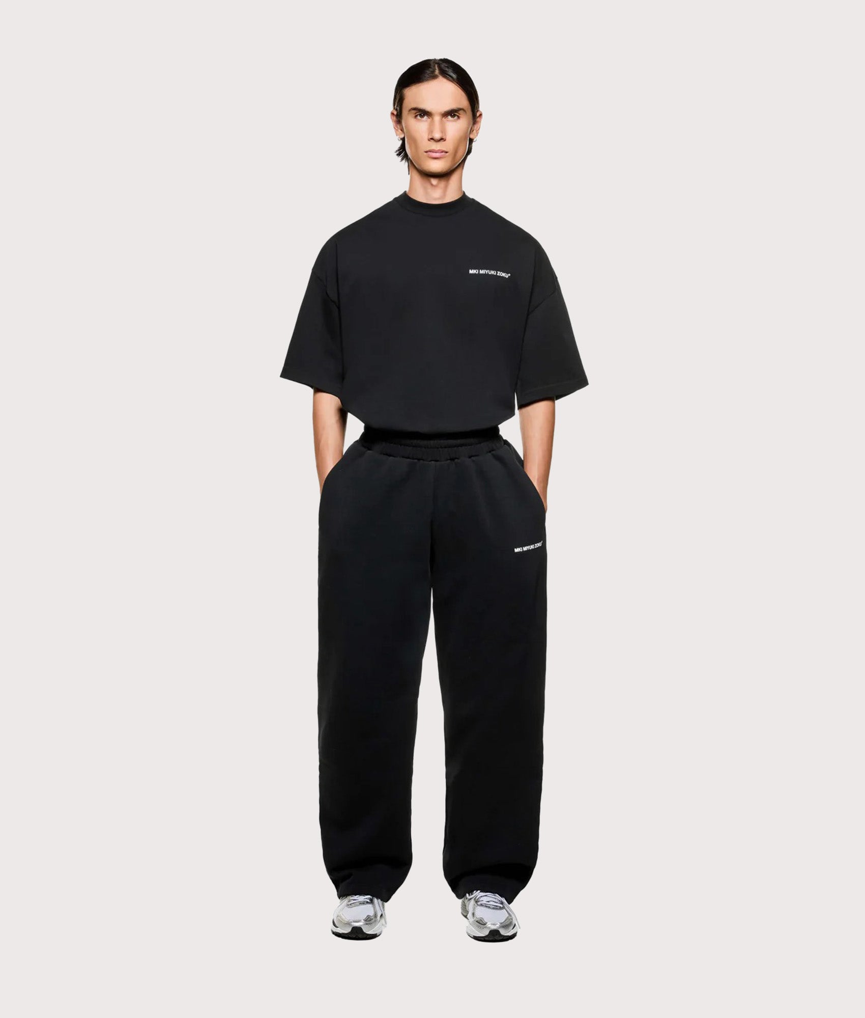 MKI MIYUKI ZOKU Uniform Wide Leg Joggers in Black at EQVVS Menswear. Full model front shot.