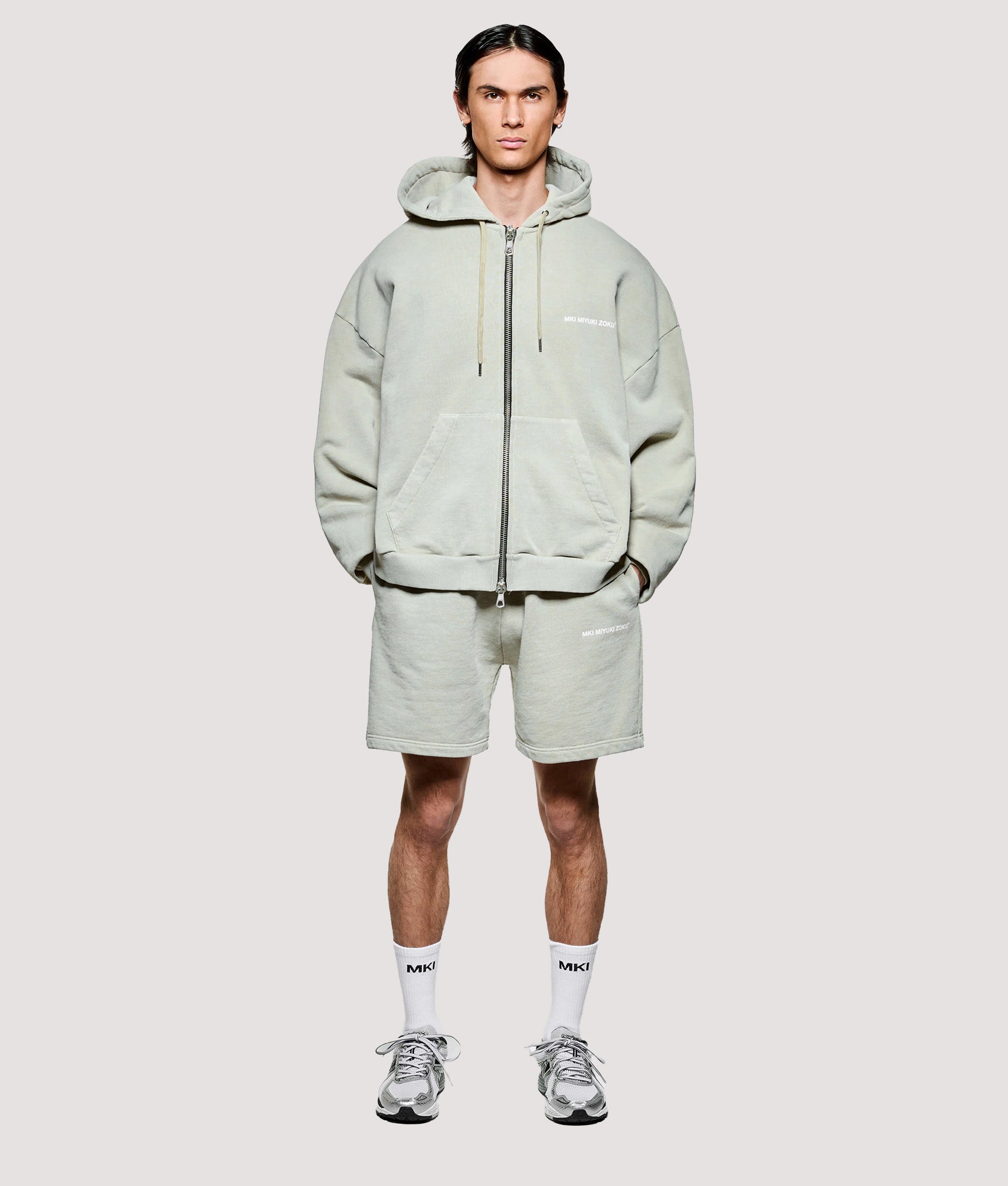 MKI MIYUKI ZOKU Box Fit Uniform Zip Through Hoodie in Pigment Cement at EQVVS Menswear. Model full front shot.