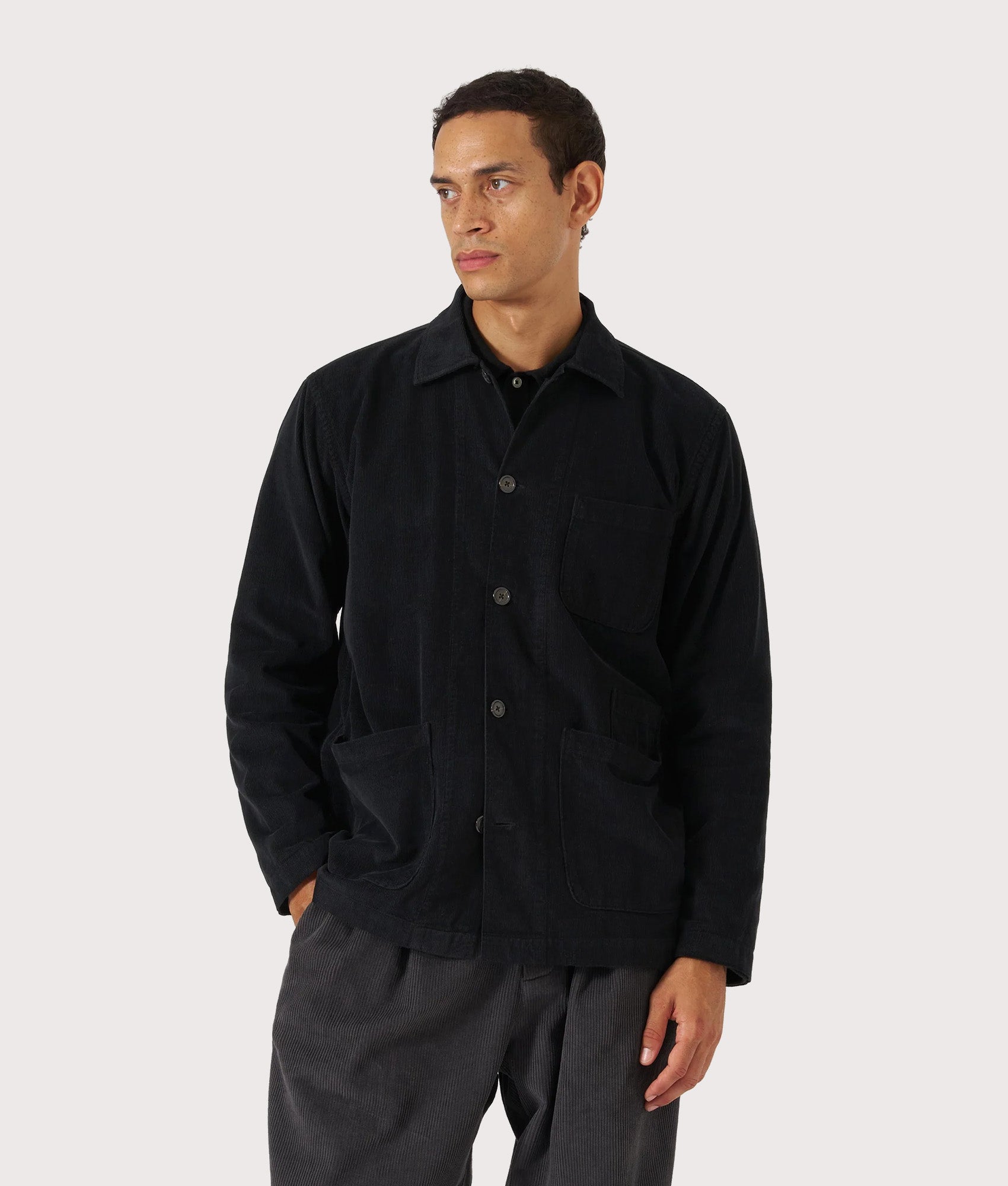Universal Works Bakers Overshirt in Black at EQVVS Menswear. Model front shot.
