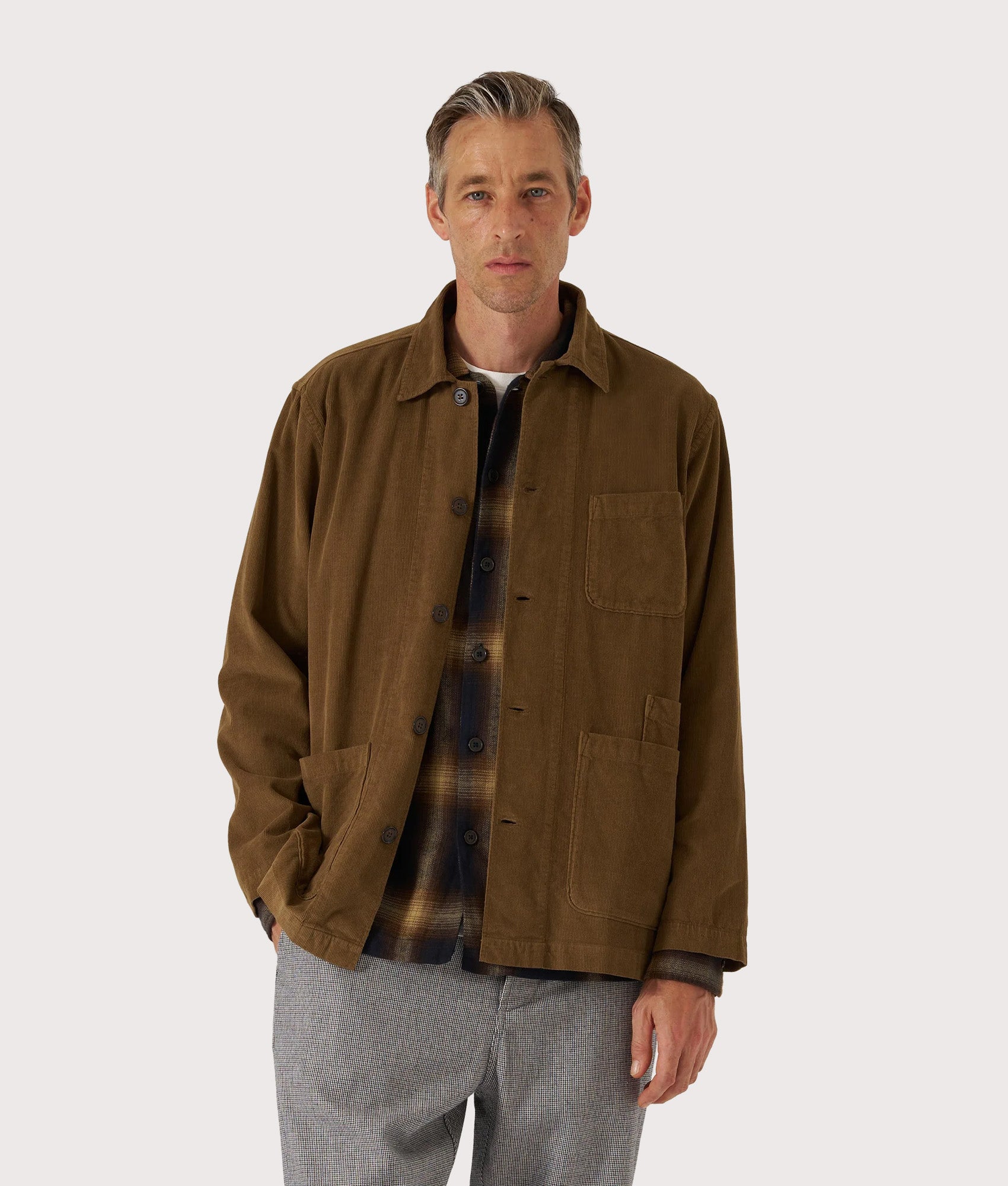 Universal Works Bakers Overshirt in Khaki at EQVVS Menswear. Model front shot.