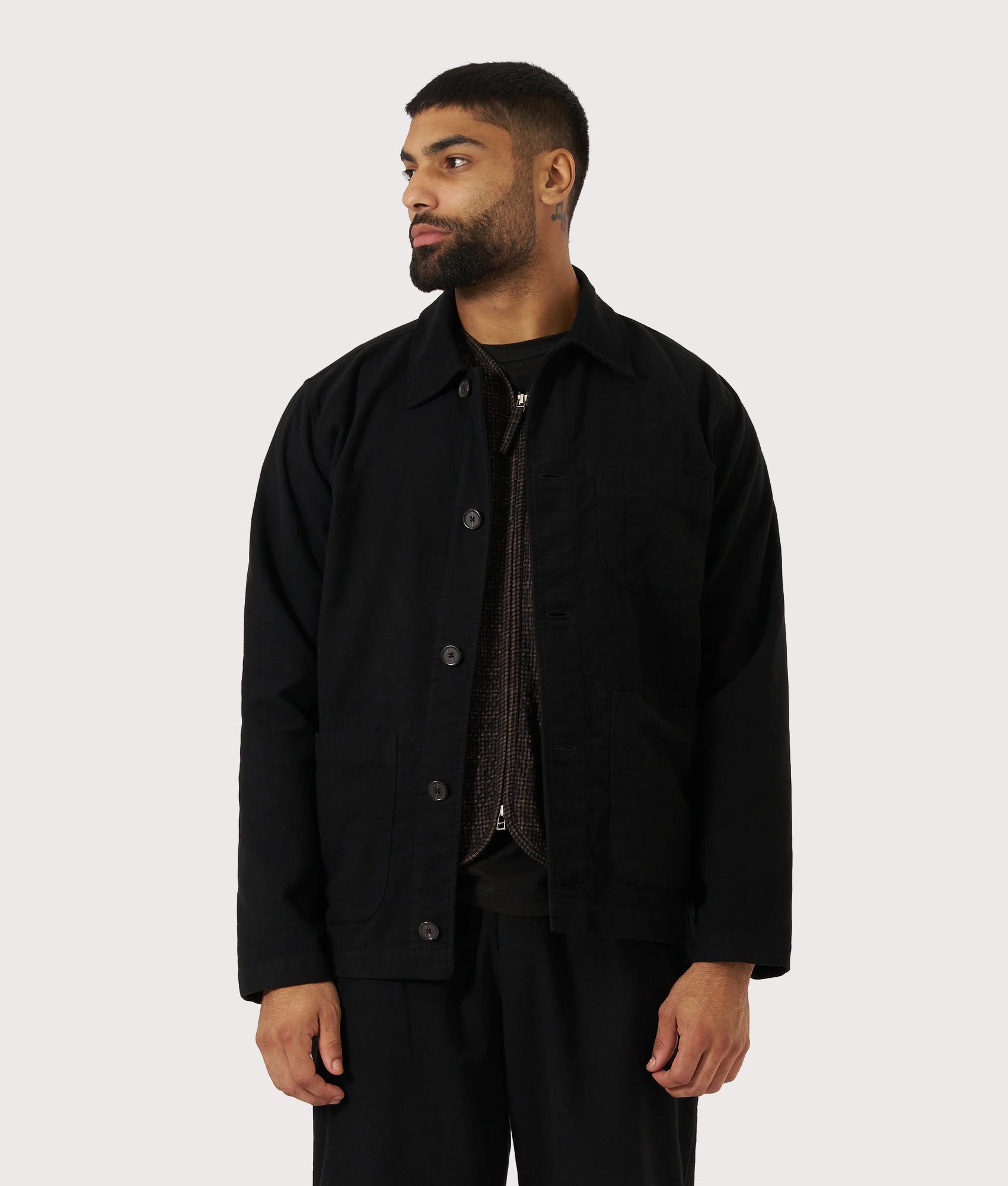 Universal Works Comfort Moleskin Field Jacket in Black at EQVVS Menswear. Model front shot.