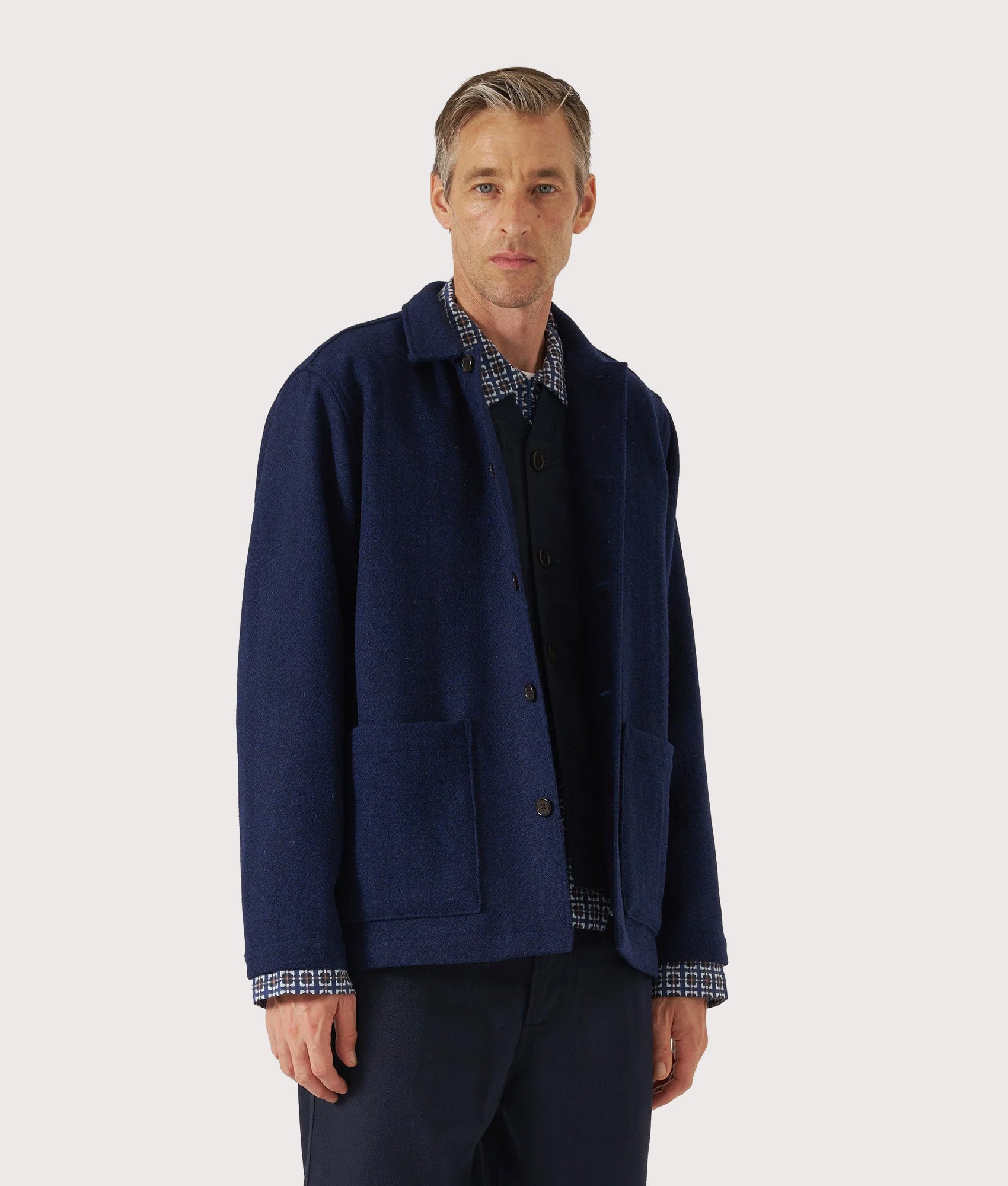 Universal Works Harris Tweed Easy Jacket in Indigo at EQVVS Menswear. Model front shot.