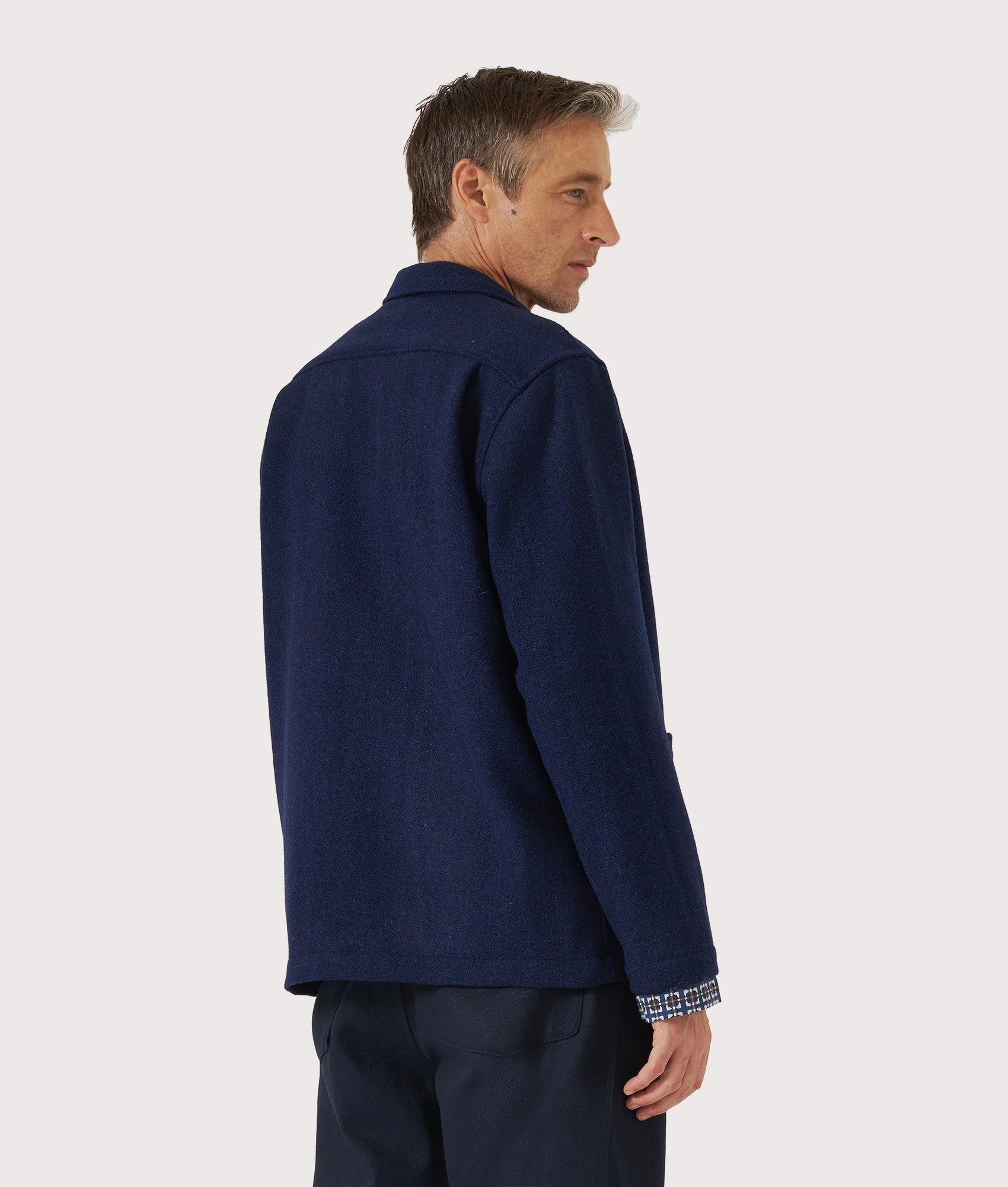 Universal Works Harris Tweed Easy Jacket in Indigo at EQVVS Menswear. Model back shot.
