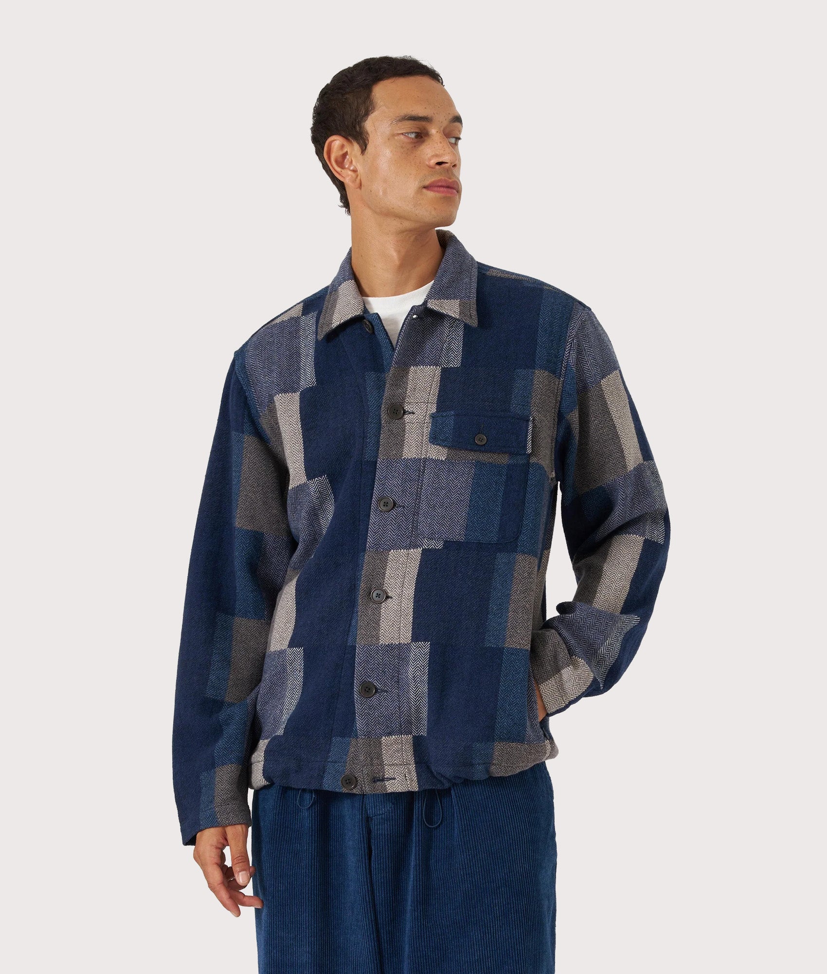 Universal Works Japanese Patchwork Tech Overshirt in Navy at EQVVS Menswear. Model front shot.