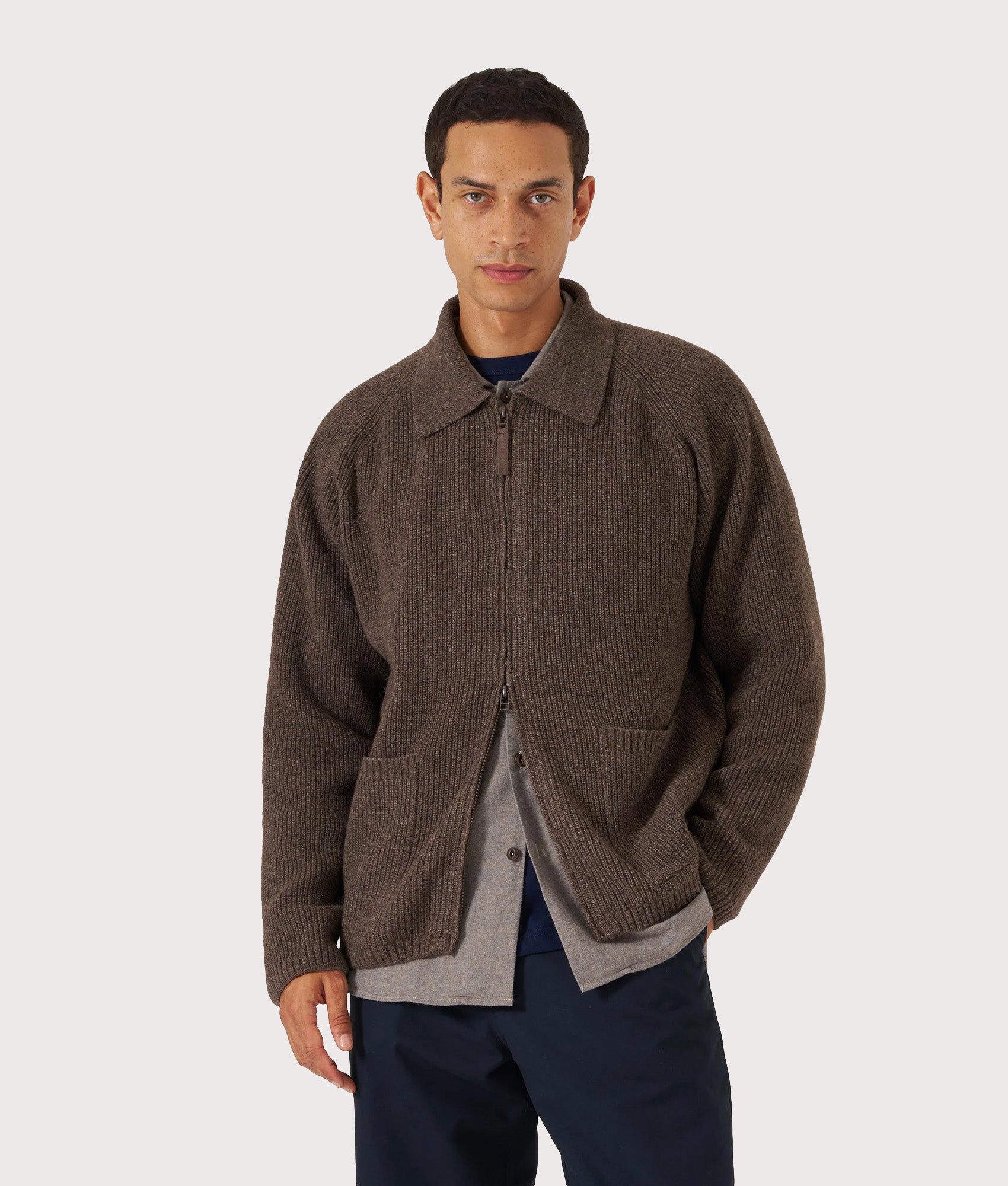 Universal Works Zip Cardigan in Brown at EQVVS Menswear. Model front shot.
