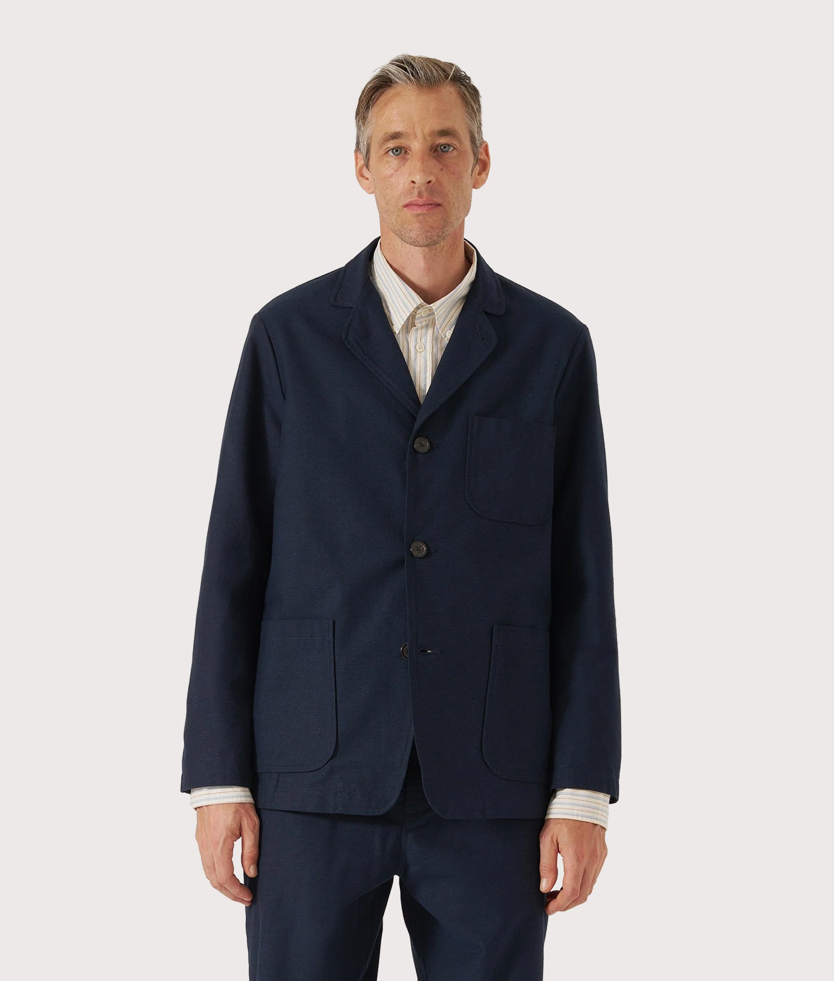 Universal Works Three Button Jacket in Navy at EQVVS Menswear. Model front shot.