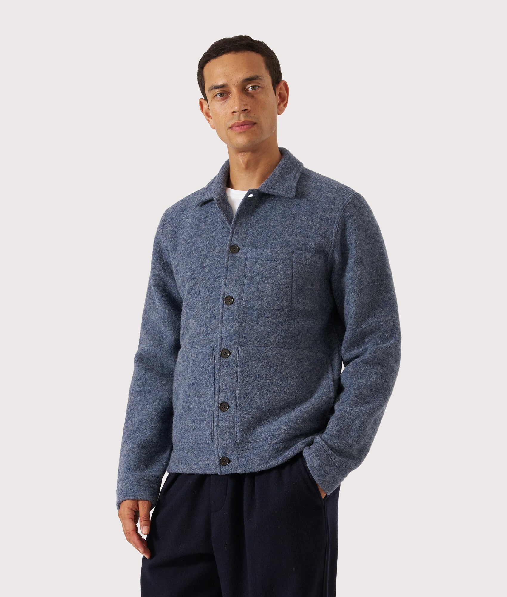 Universal Works Uniform Jacket in Slate Blue at EQVVS Menswear. Model front shot.