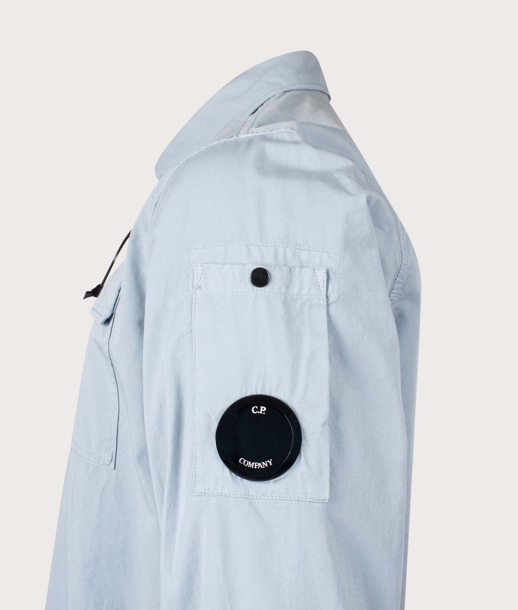 C.P Company Gabardine Zipped Lens Overshirt in Silver Blue at EQVVS Menswear. Detail shot.