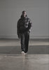 MKI MIYUKI ZOKU Translucent Bubble Jacket in Black at EQVVS Menswear. Side Model Shot. Catwalk Video 