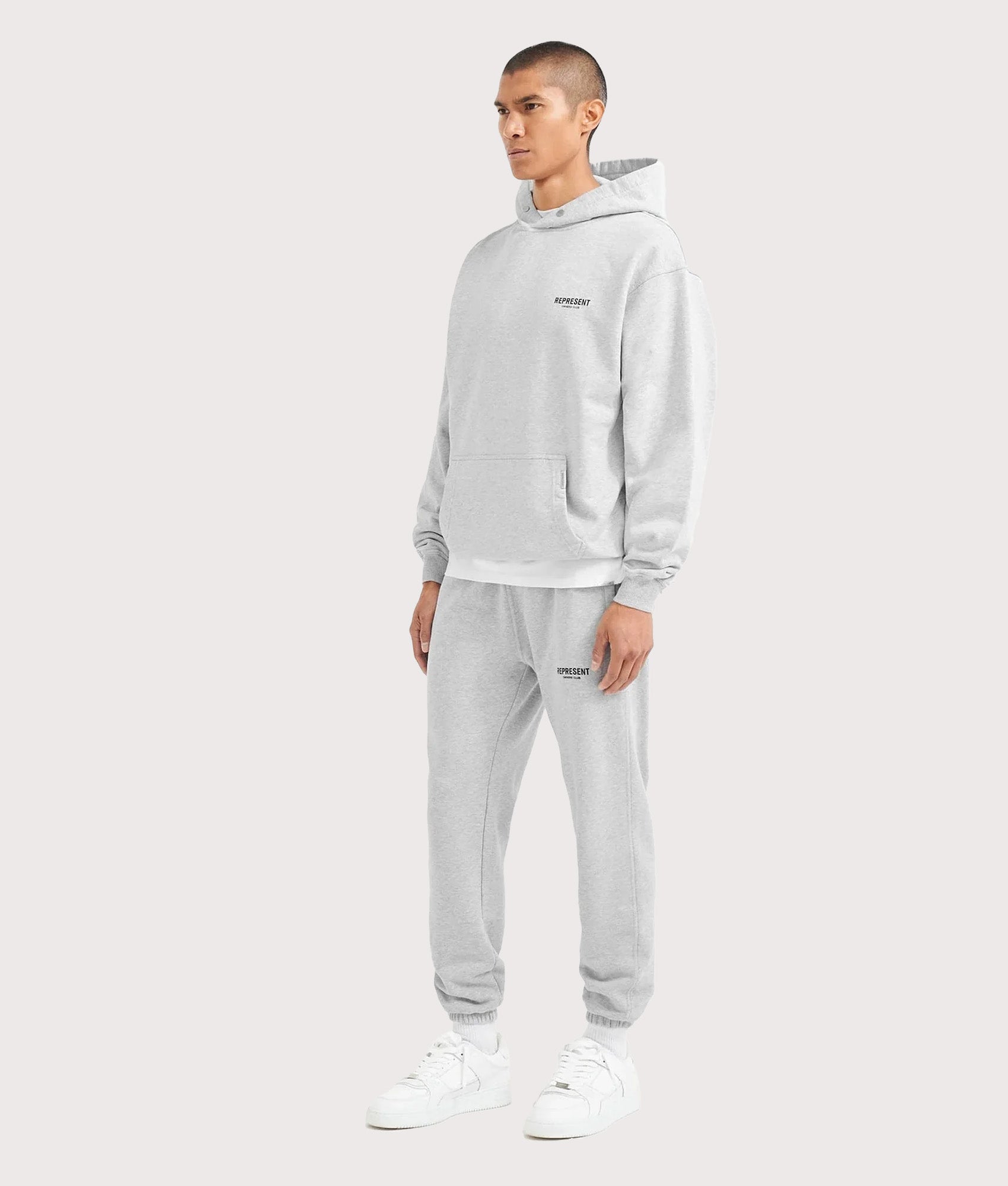 REPRESENT Oversized Fit Represent Owners Club Hoodie in Ash Grey at EQVVS Menswear. Model full front angle shot.