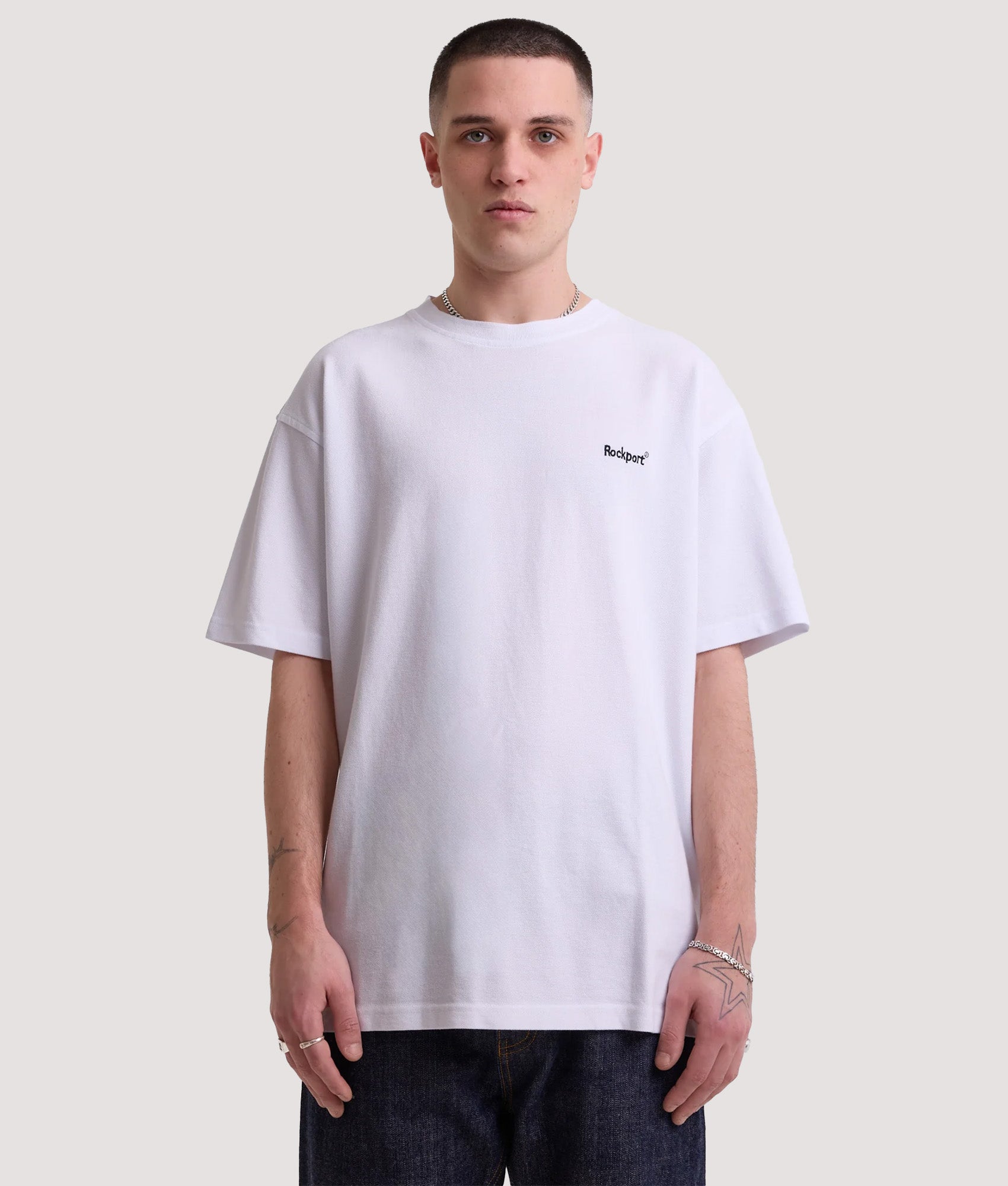 Rockport Relaxed Fit Rocester Piqué Logo T-Shirt in White at EQVVS Menswear. Model front shot.