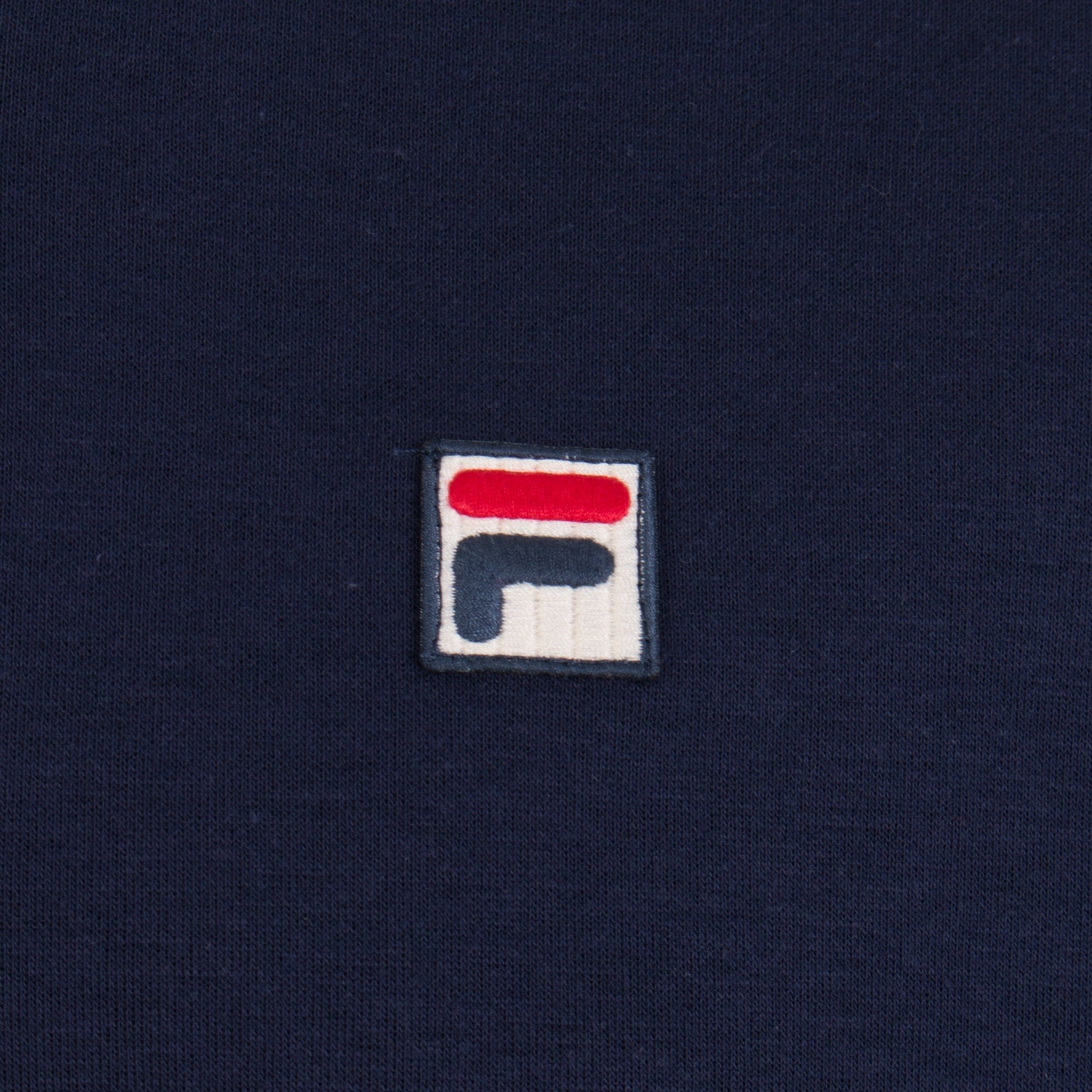 FILA Settanta Baseball Track Jacket in Peacoat, Gardenia and Chinese Red at EQVVS Menswear. Detail shot.