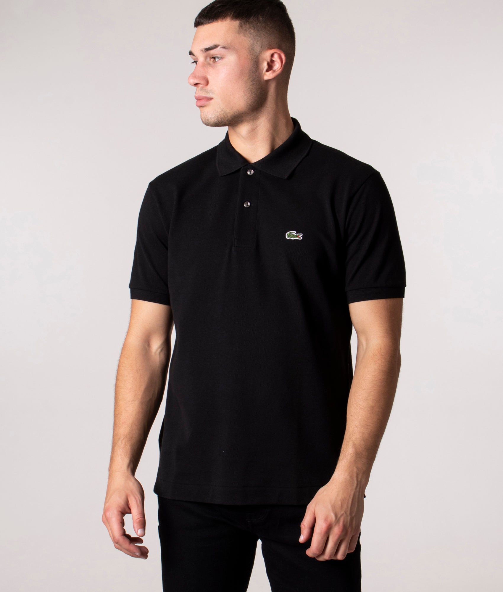 Lacoste Classic Fit L1212 Croc Logo Polo Shirt in Black at EQVVS Menswear. Angled front shot.