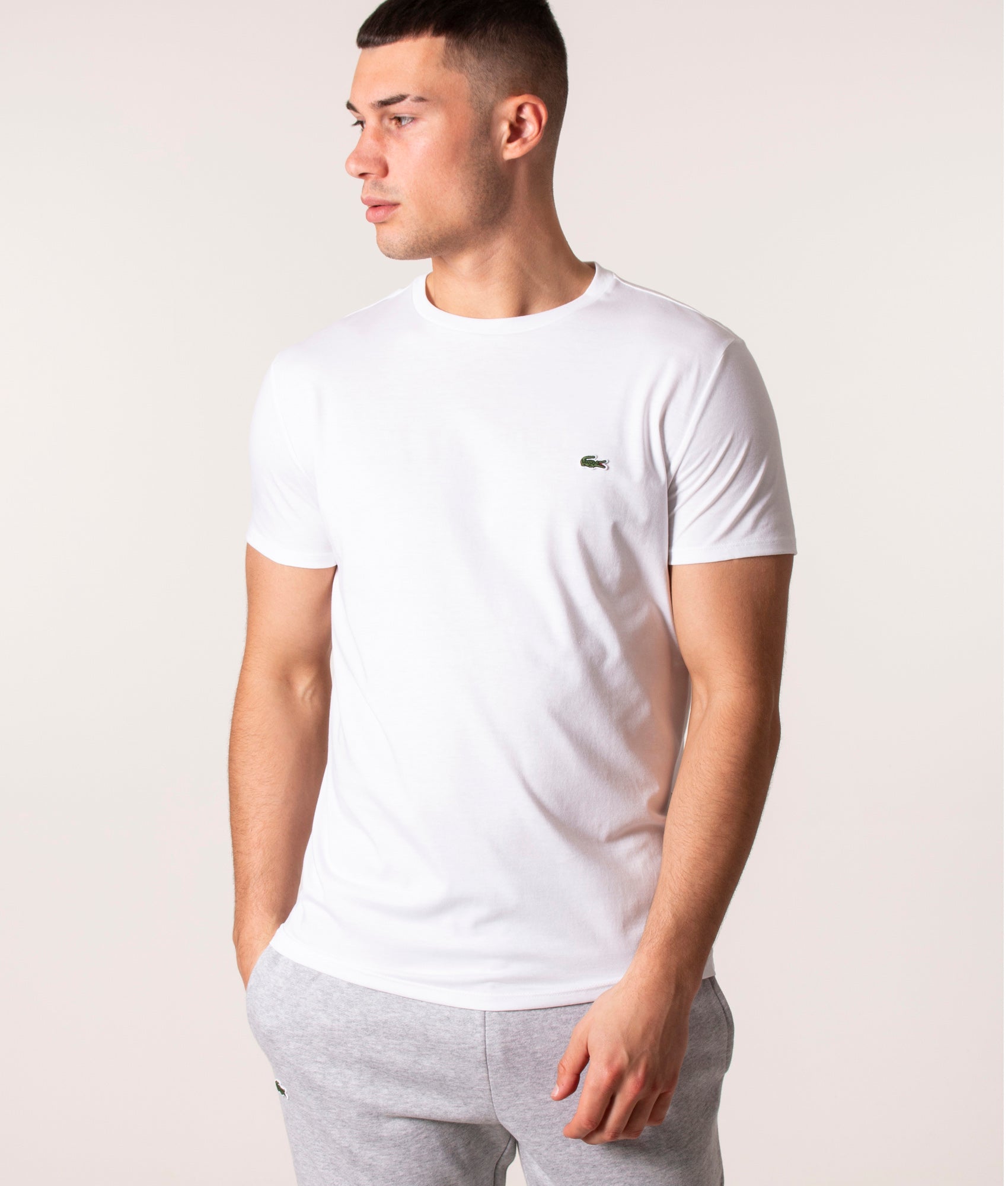 Lacoste Pima Cotton Croc Logo T-Shirt in White at EQVVS Menswear. Model front shot.